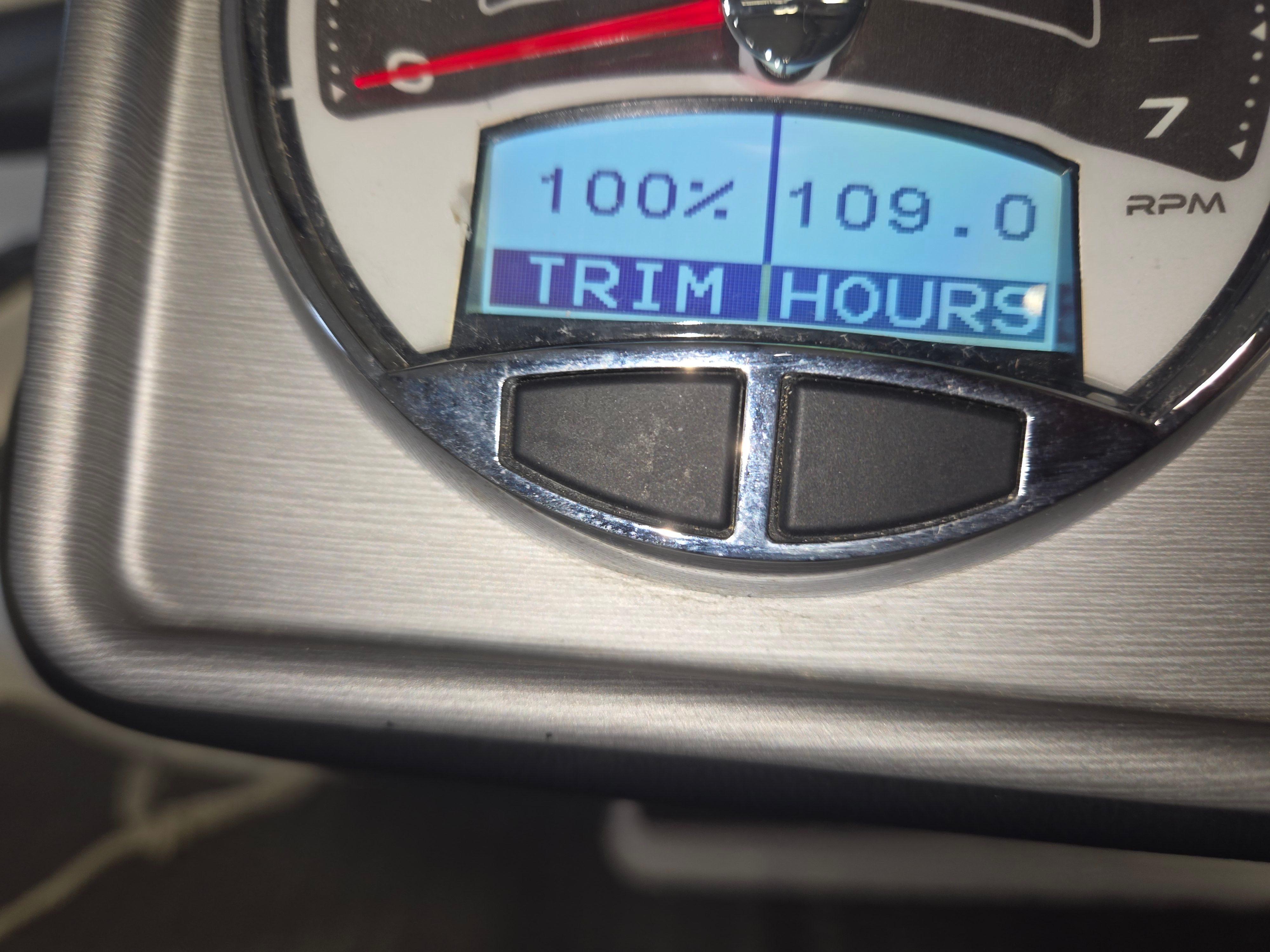 Close-up of a boat display showing trim and engine hours.
