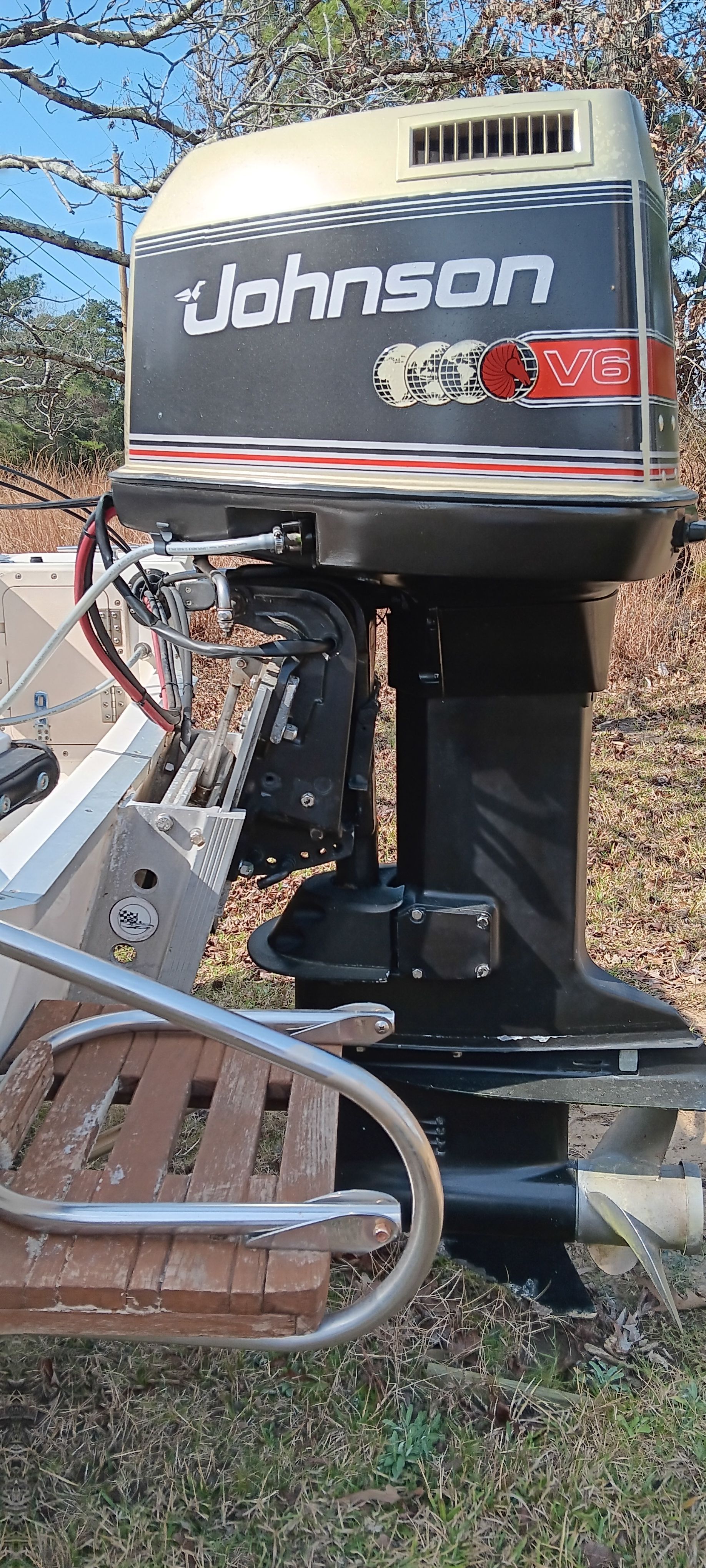 Outboard motor of a boat with Johnson V6 logo, mounted on a 1990 Hydra-Sports Vector.