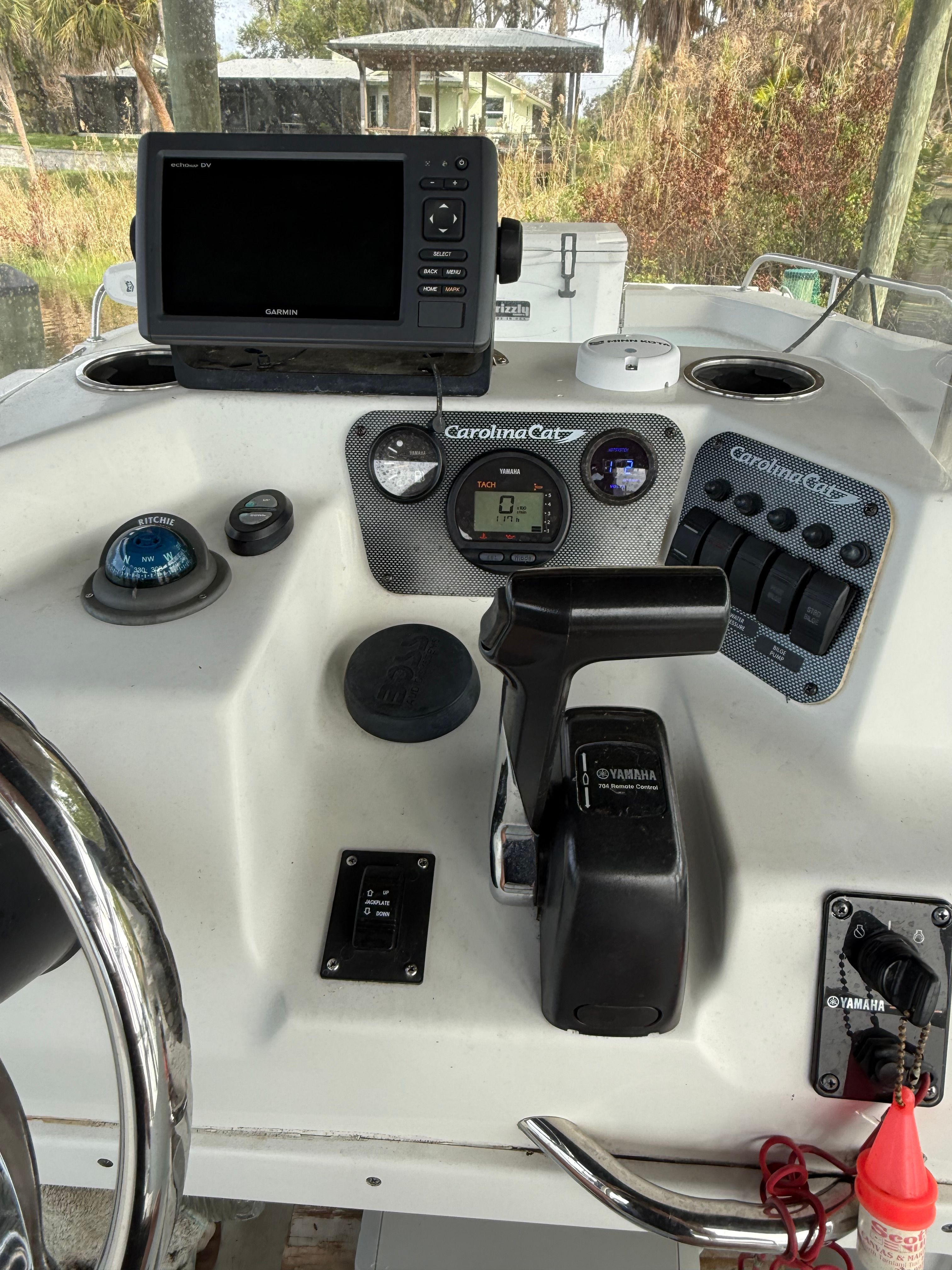 The dashboard of a Carolina Cat 18CC boat with controls and navigation system.