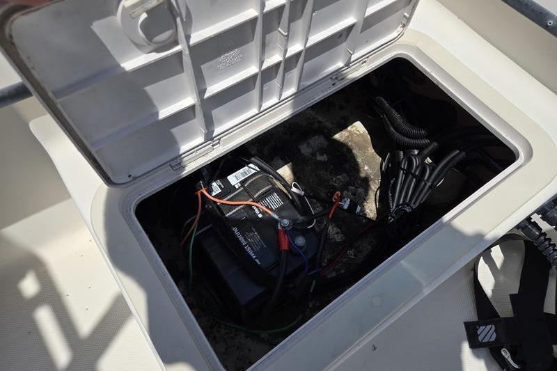 Open hatch on 2000 May-Craft 2000CC boat showing battery and wiring.