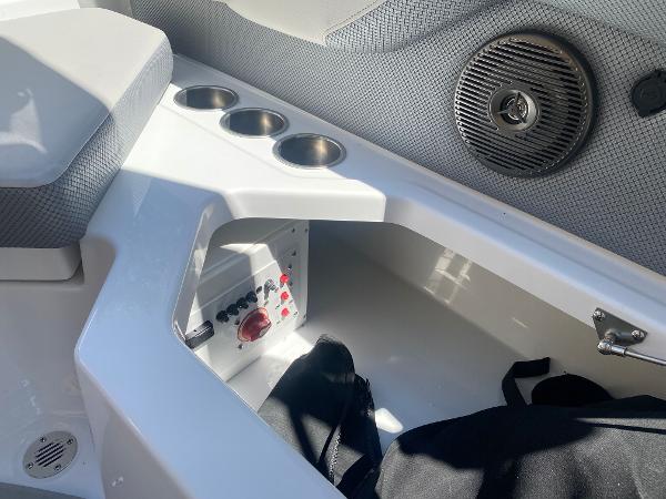 2025 Scarab 235 SE boat interior with cup holders and storage compartment.