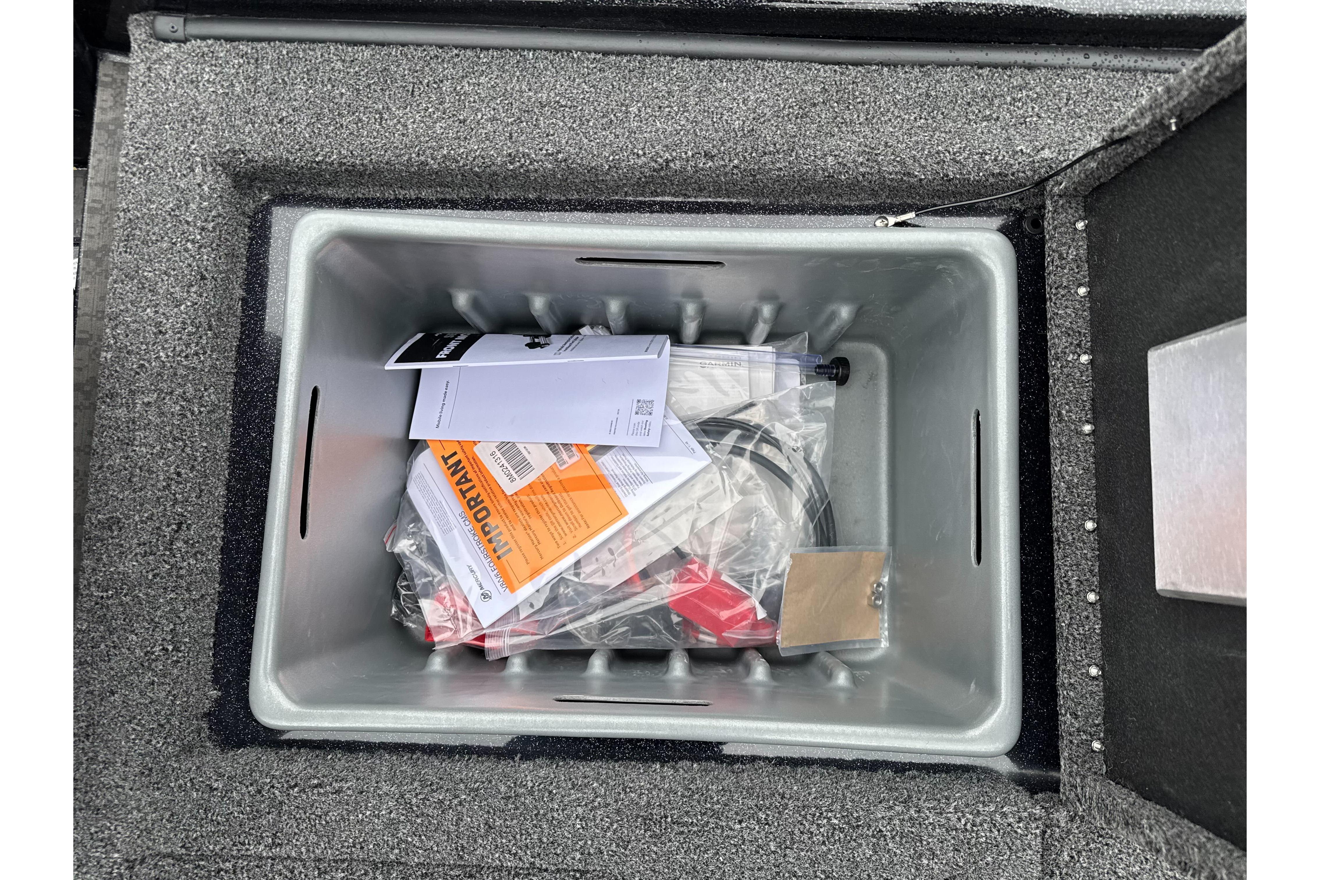 Storage compartment of 2026 Nitro Z20 XL Pro boat with manuals and accessories.