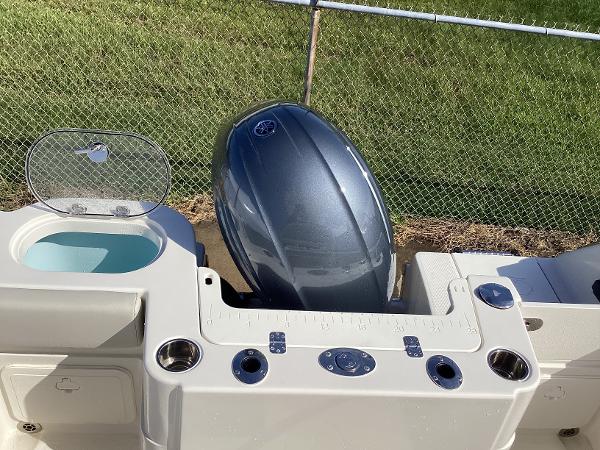 2022 Sailfish 220 CC boat with outboard motor and fishing rod holders.