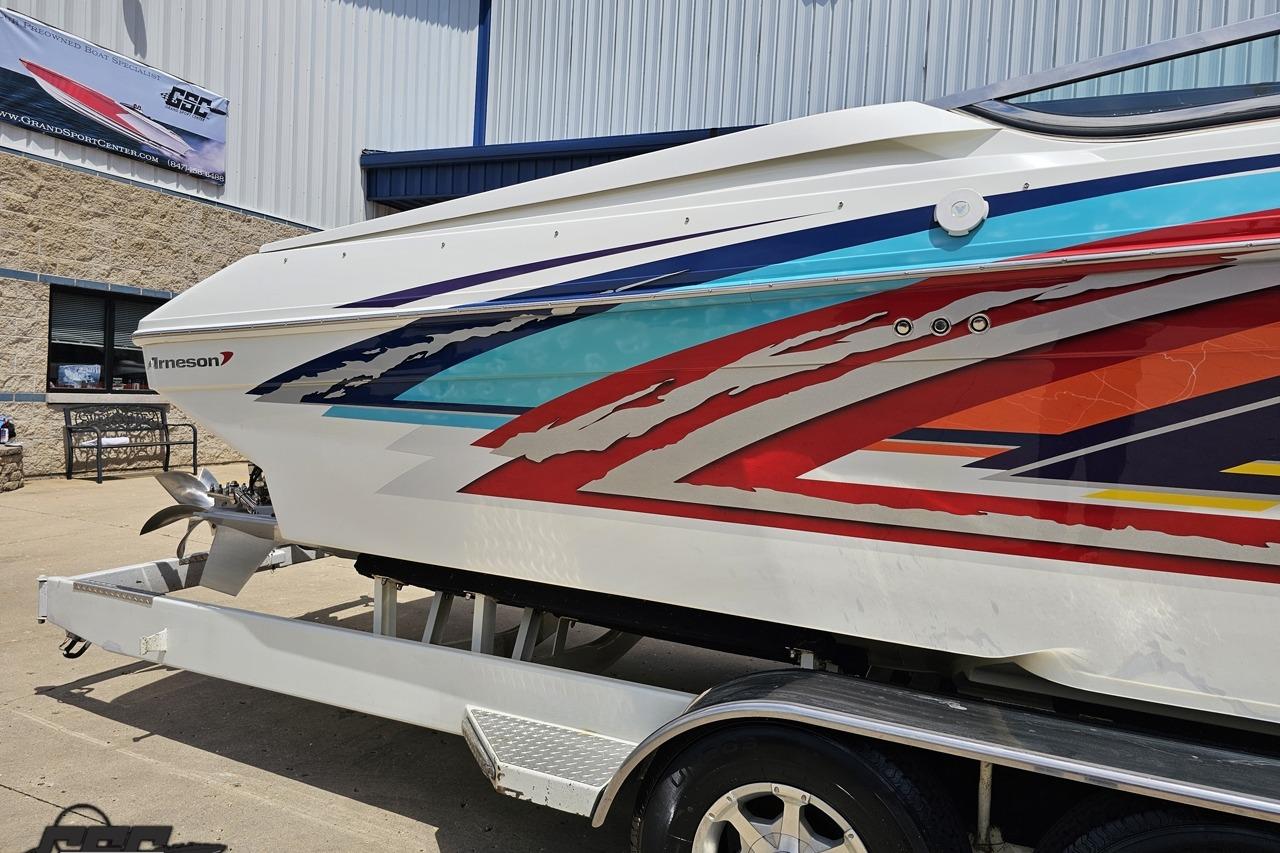 2002 Formula 382 FASTech boat with vibrant graphics on a trailer.