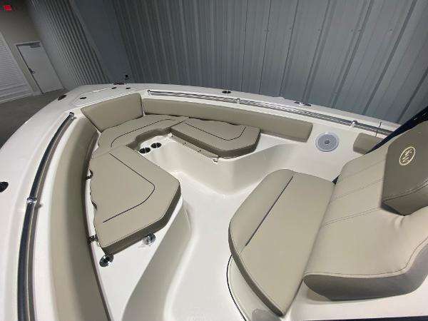 2024 Key West 219 FS boat interior with cushioned seating and storage compartments.
