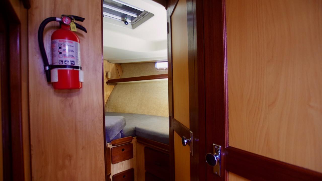 1981 Morgan Out Island 41 cabin interior with fire extinguisher and wooden furnishings.