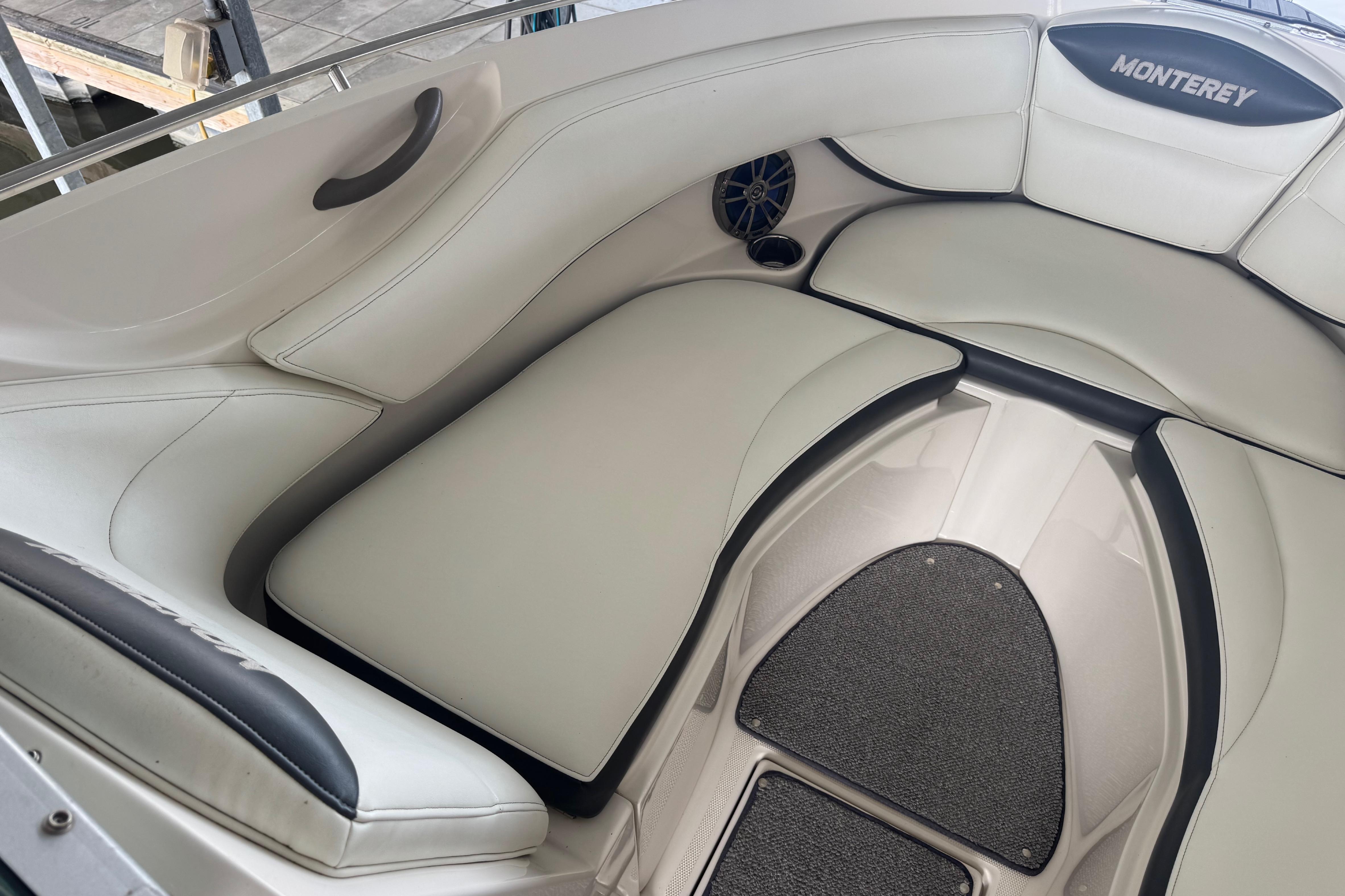 2005 Monterey 248LS Montura Bowrider interior with white cushioned seating and speaker.
