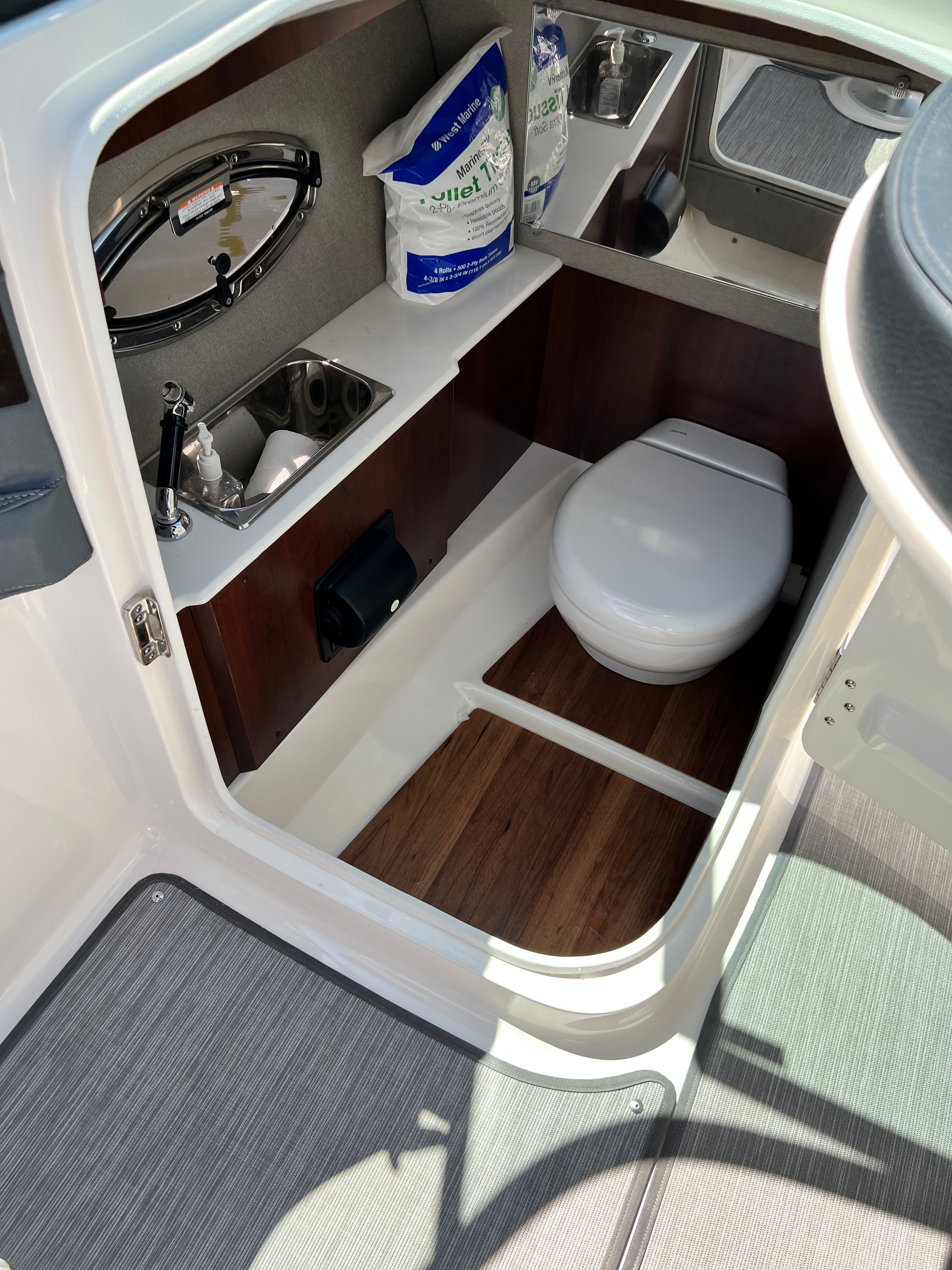 Interior of 2020 Chaparral 256 SSX featuring toilet and sink.