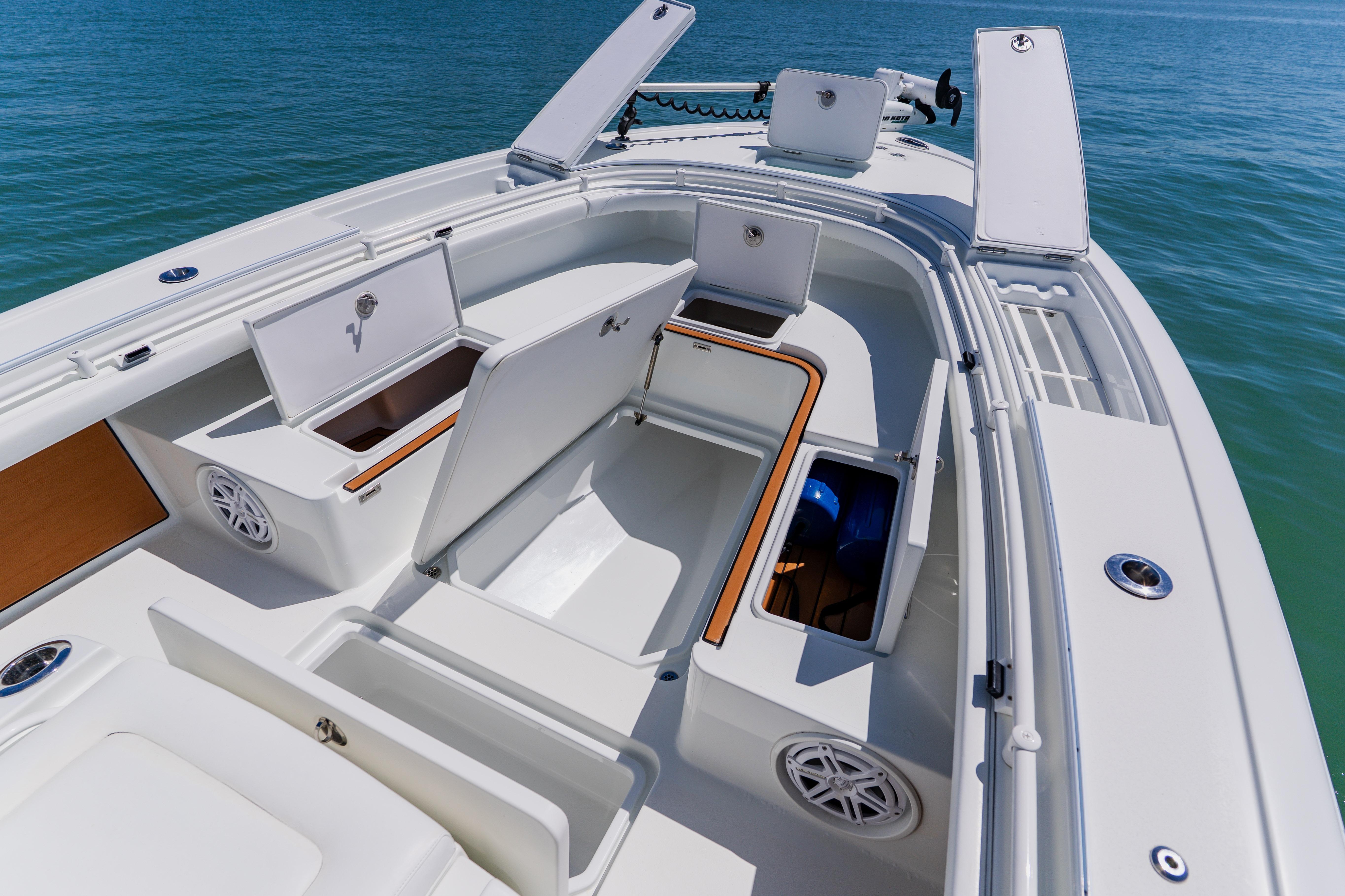 2017 Barker Boatworks 26 with open storage compartments on a calm sea.