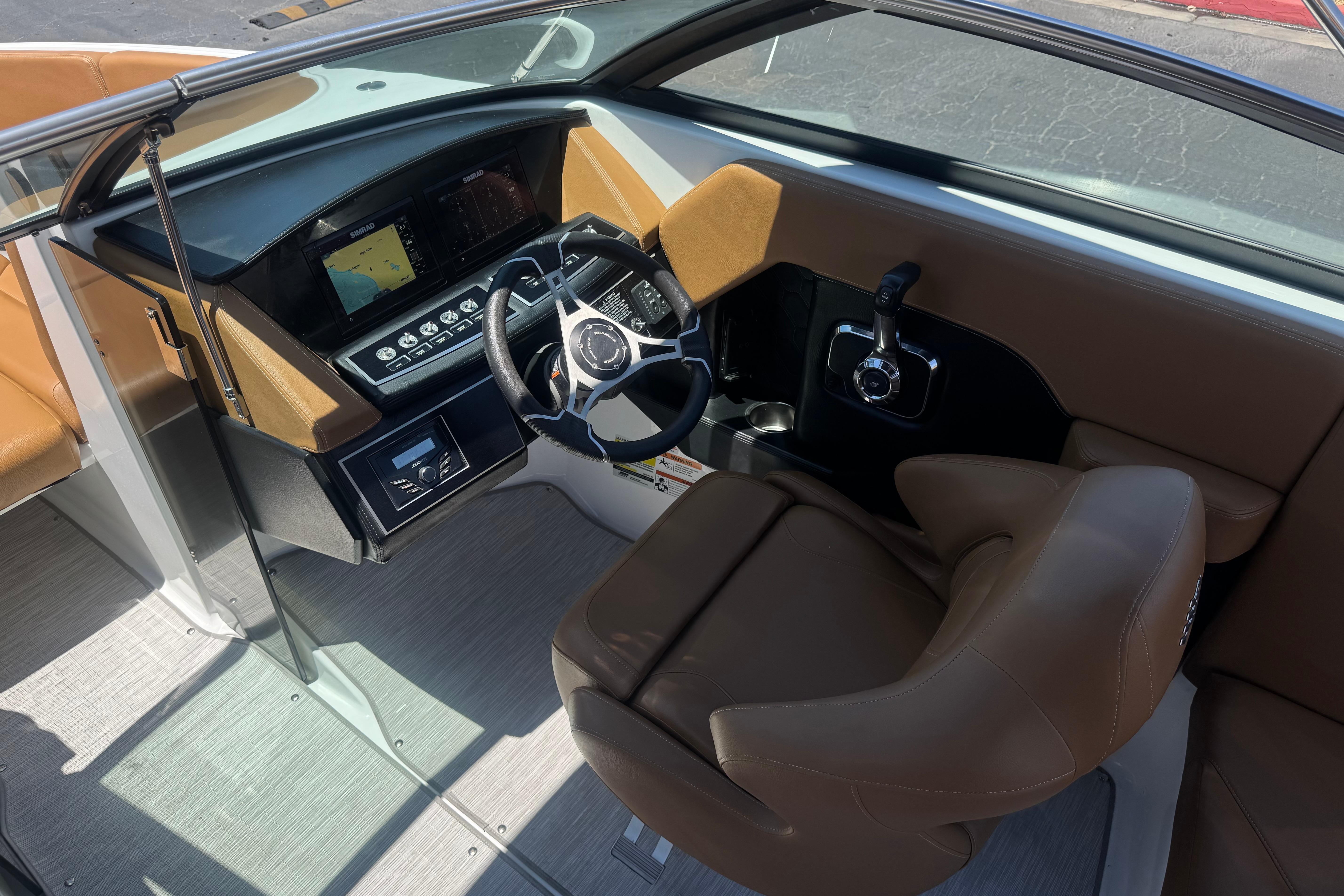2022 Four Winns H4 boat cockpit with modern steering and navigation system.