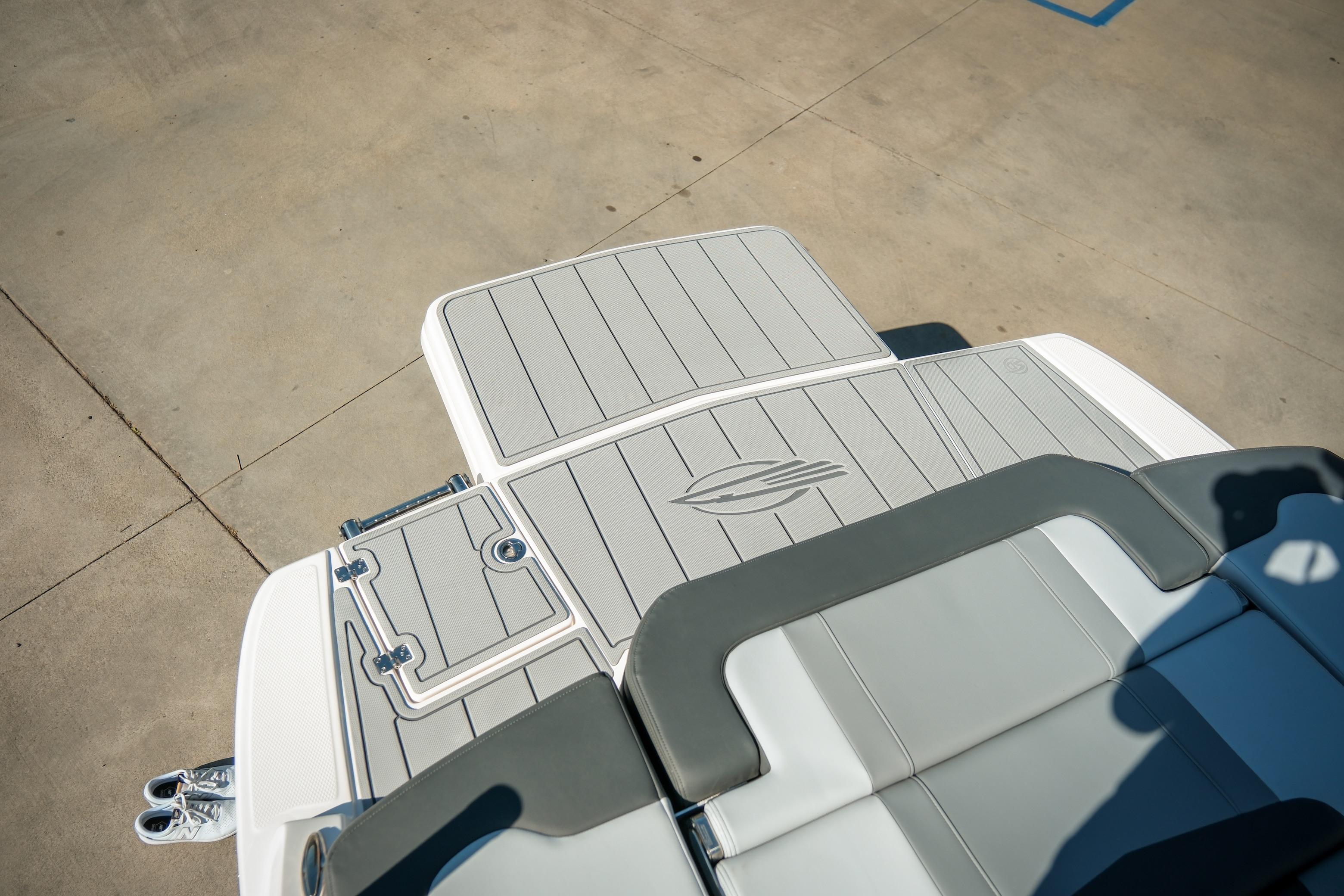 2026 Chaparral 23 SSi boat deck with sleek gray seating and storage compartments.