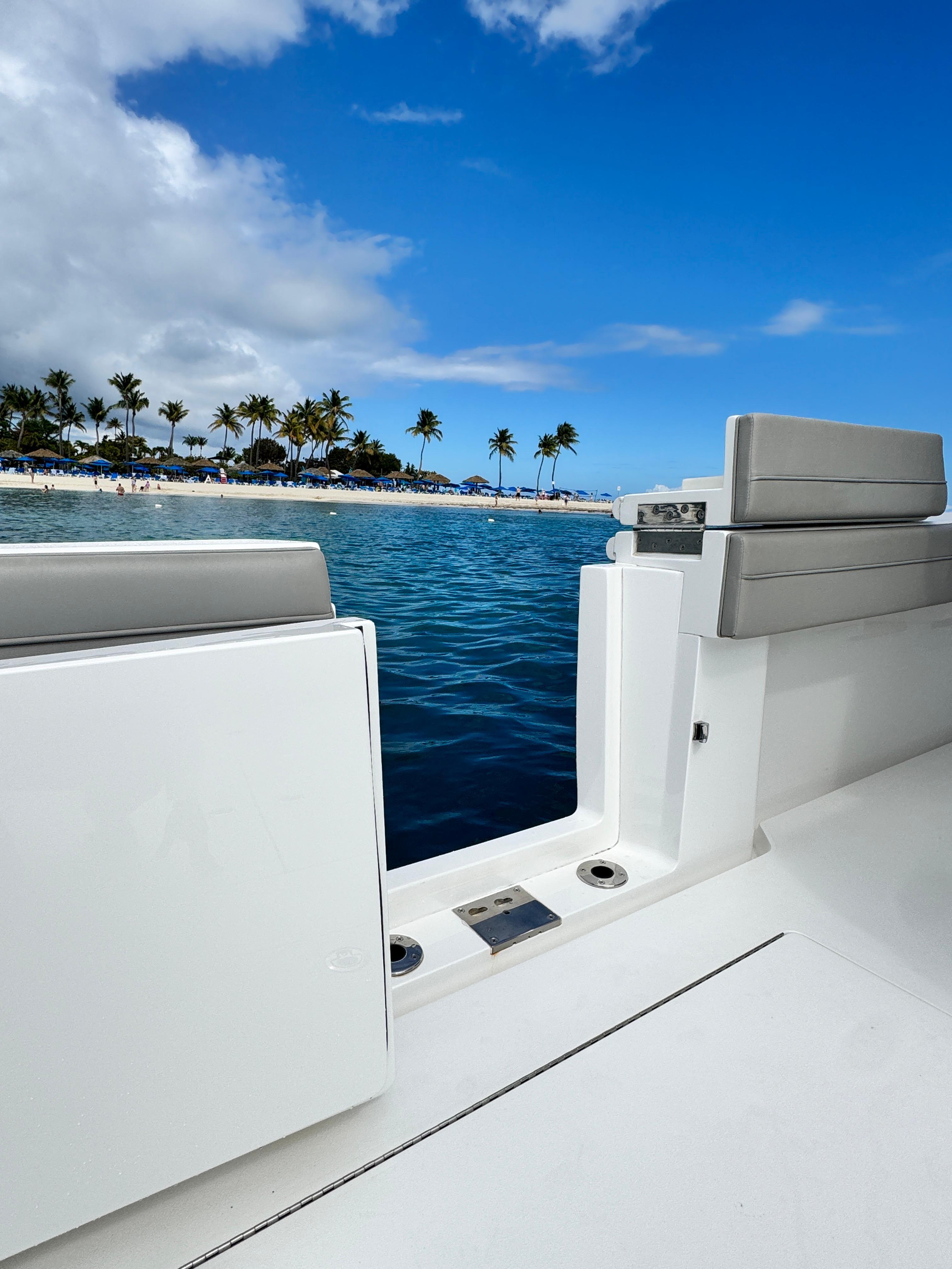 2023 Valhalla Boatworks V-46 on tropical water with palm trees in background.