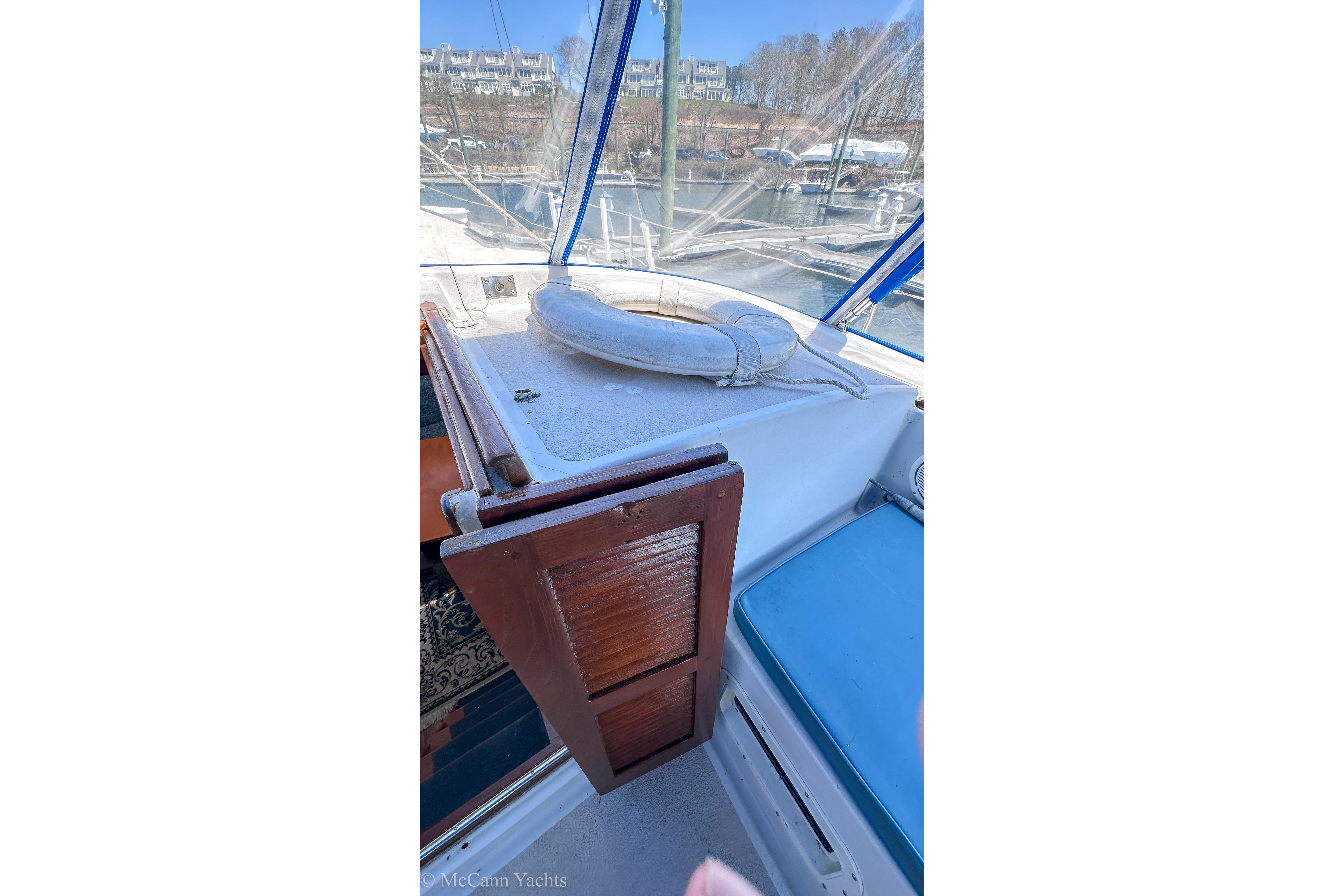 1980 Irwin 46 yacht cockpit with wooden hatch and blue seating.