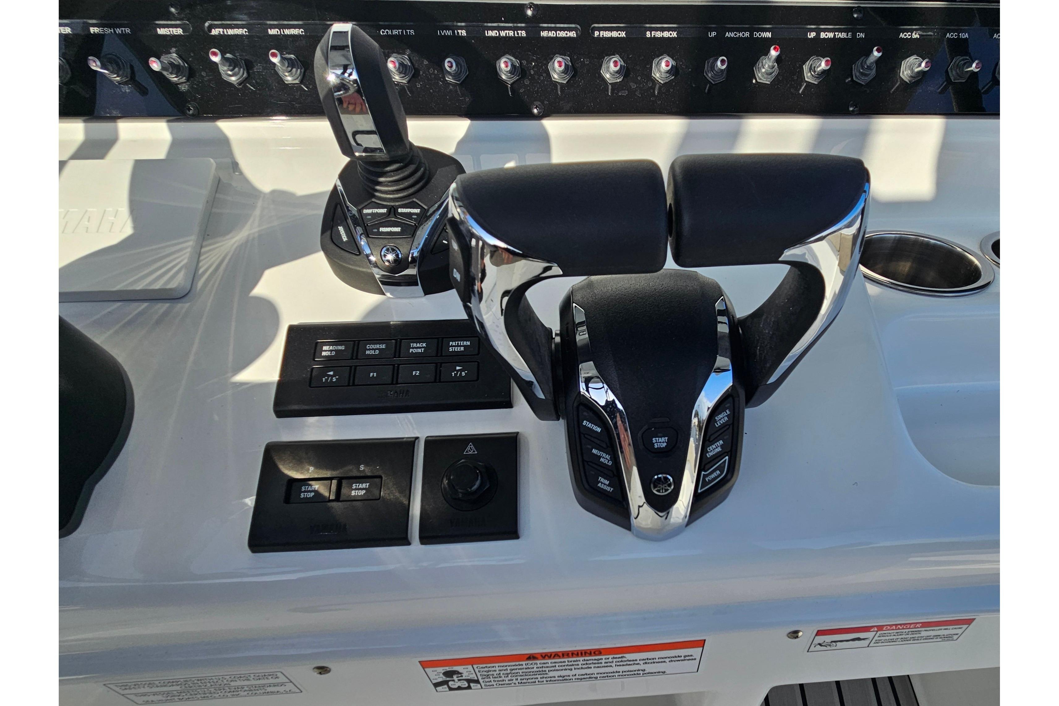 Control panel of 2026 Sea Hunt Ultra 285 SE boat with throttle and switches.