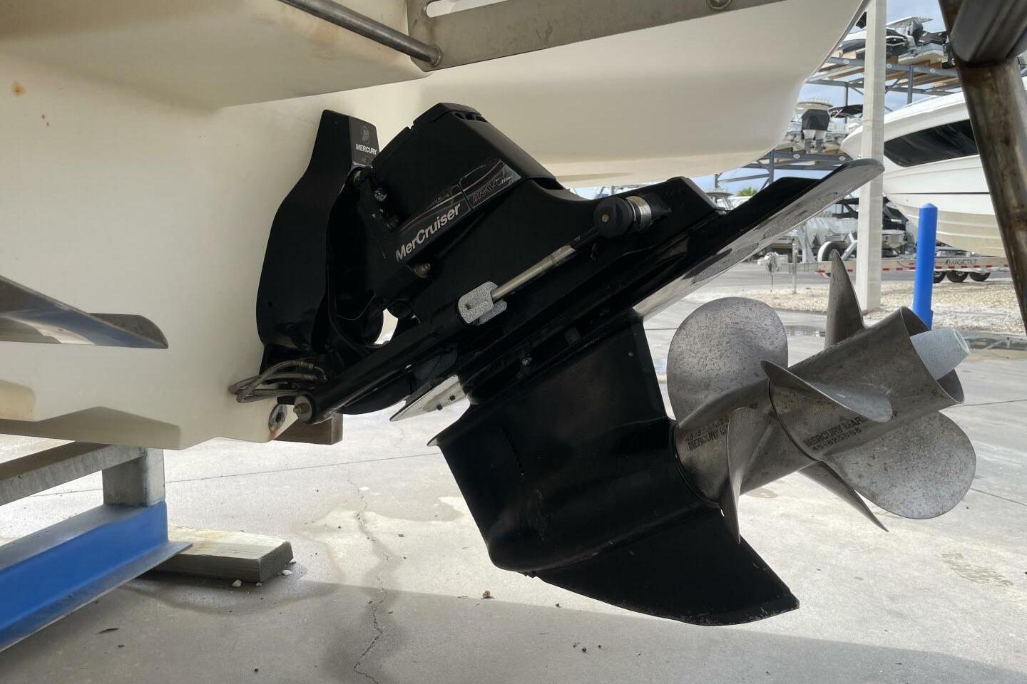 2008 Sea Ray 270 SLX boat with MerCruiser outdrive and propeller, docked on a stand.
