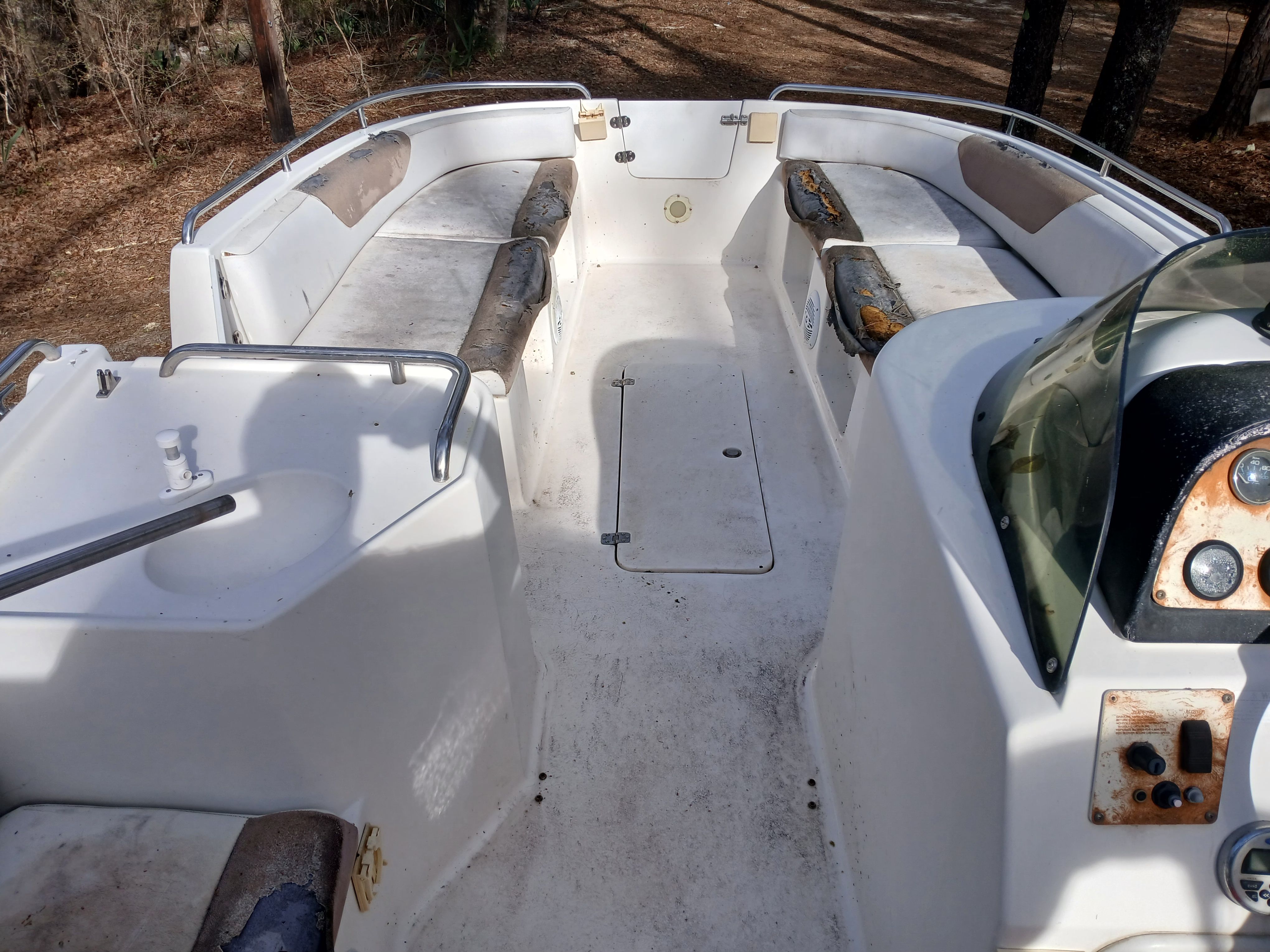 The image shows the cockpit of a 1996 Cobia 229SPO boat with seating and a helm console.