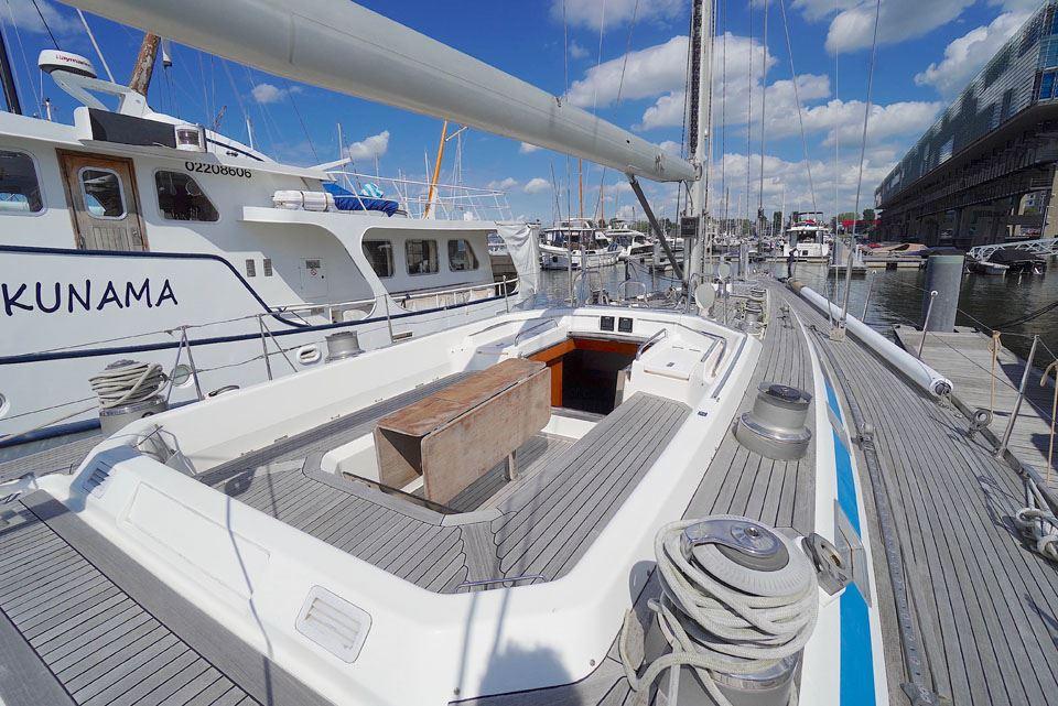 Sailing yacht Nautor Swan 60, 1995 model, docked at marina with clear skies.