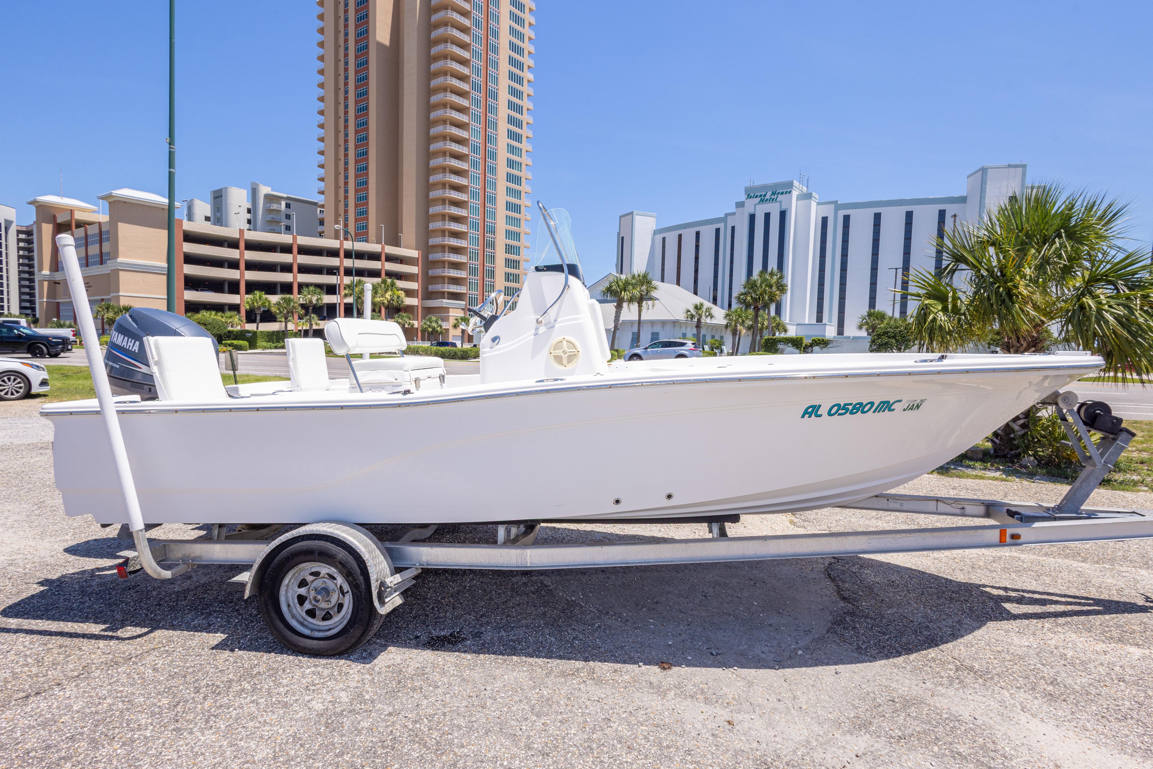 2011 Sea Fox 200XT boat on trailer, urban background with tall buildings and palm trees.