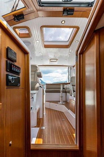 Interior of 2024 True North 34 boat with wooden finish and skylights.