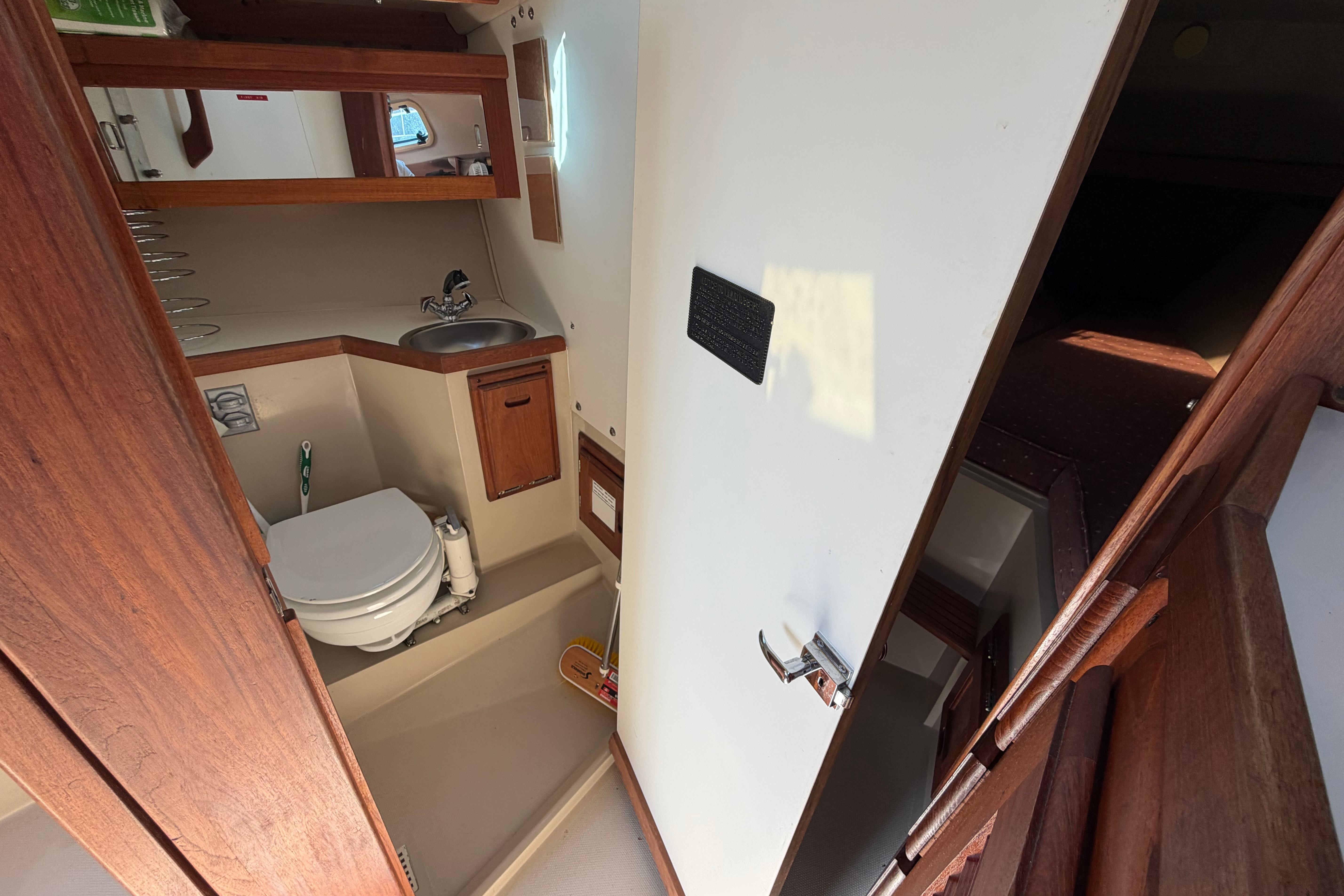 Interior of 1988 Catalina 30 MkII sailboat bathroom with sink and toilet.