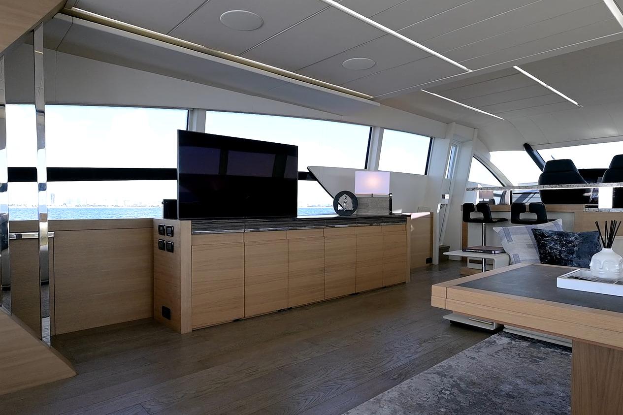 Luxurious interior of a 2015 Pershing 92 yacht with modern furnishings and panoramic windows.