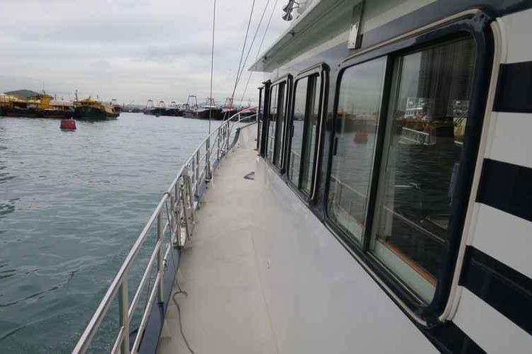 Side view of a 2014 Diesel Duck 54 yacht on calm waters.