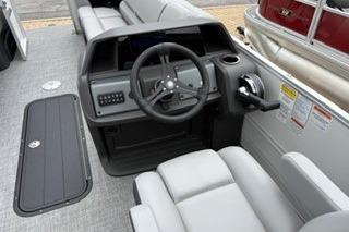 2026 Sun Tracker Party Barge 22 XP3 boat interior with steering console and seating.