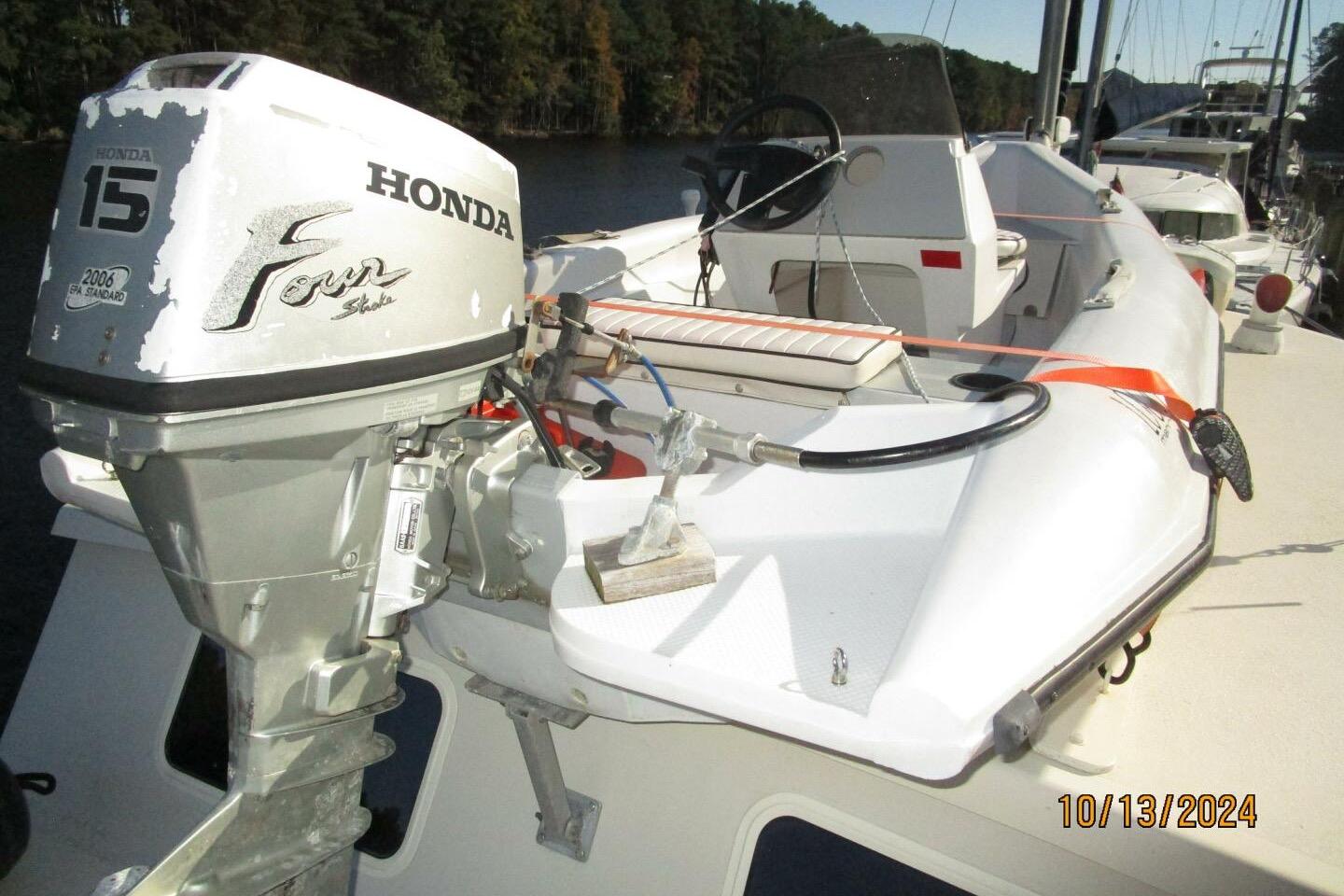 1997 Rosborough Trawler with Honda 15 outboard motor, docked on a sunny day.