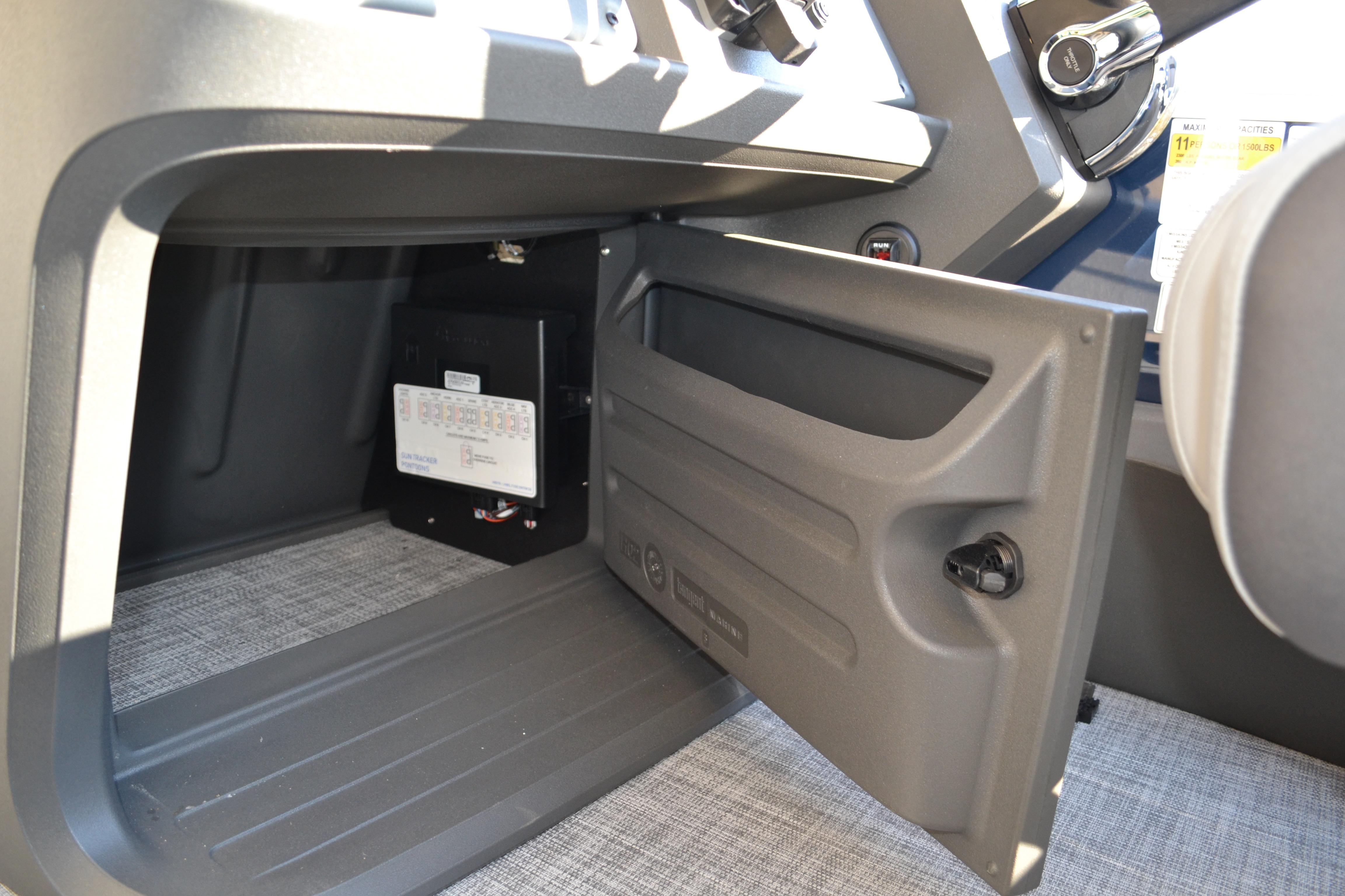 2026 Sun Tracker SportFish 22 XP3 storage compartment with open door, revealing interior details.
