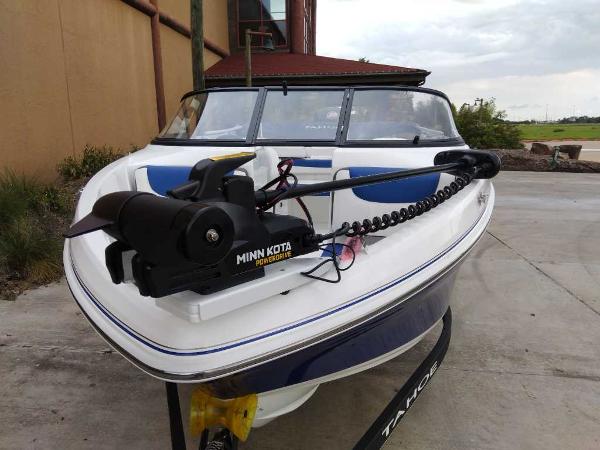 2024 Tahoe 185 S boat with Minn Kota trolling motor, parked outdoors.