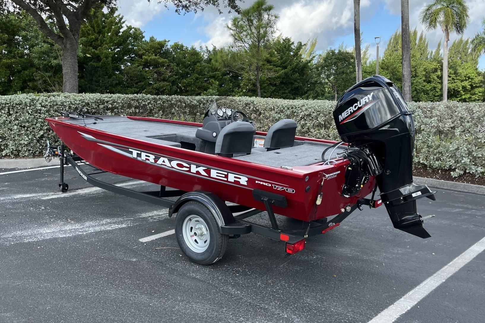2026 Tracker Pro 170 boat with Mercury engine in parking lot.