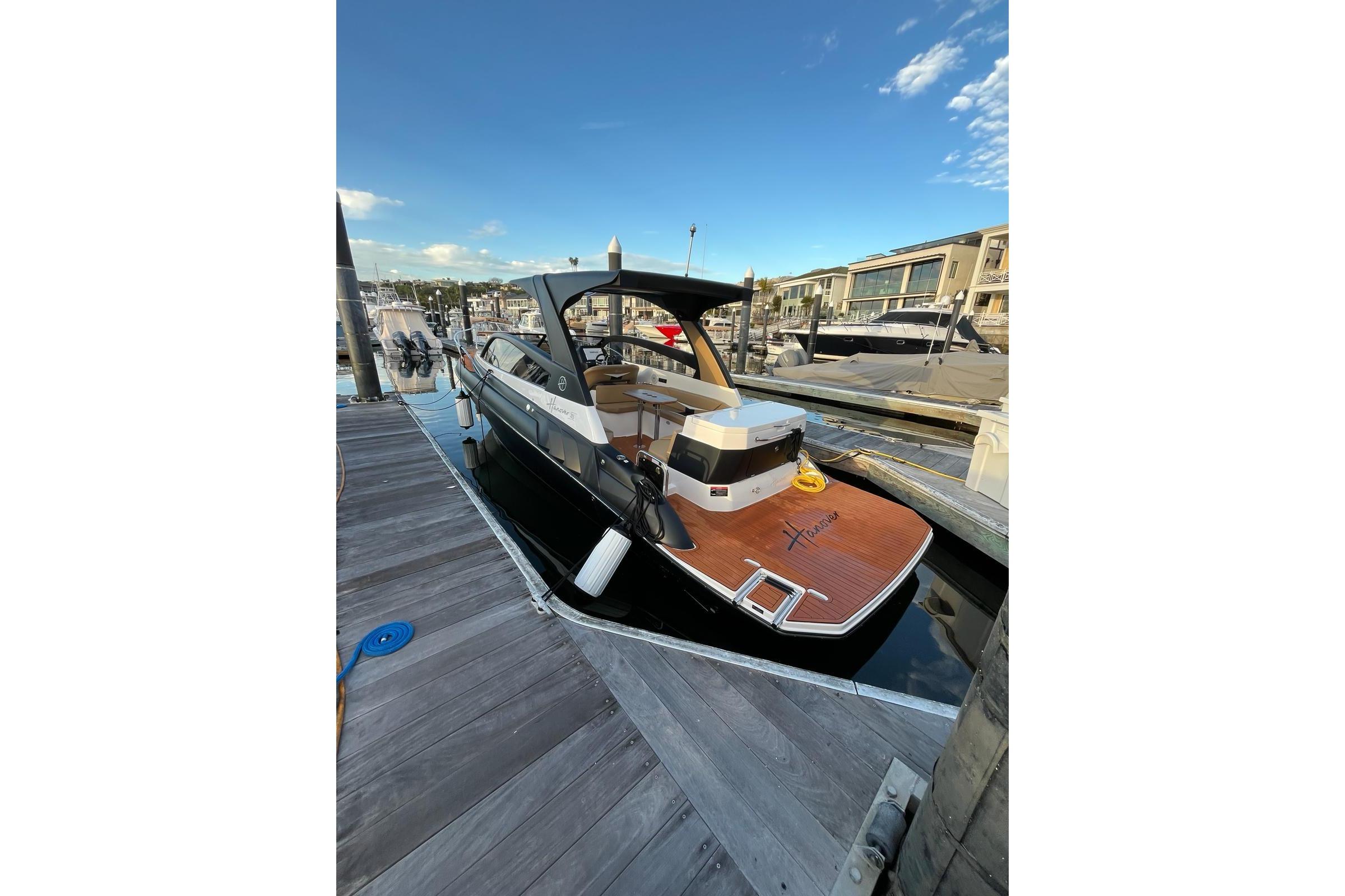 Luxury Hanover 305 yacht docked at marina, 2026 model, sunny day.
