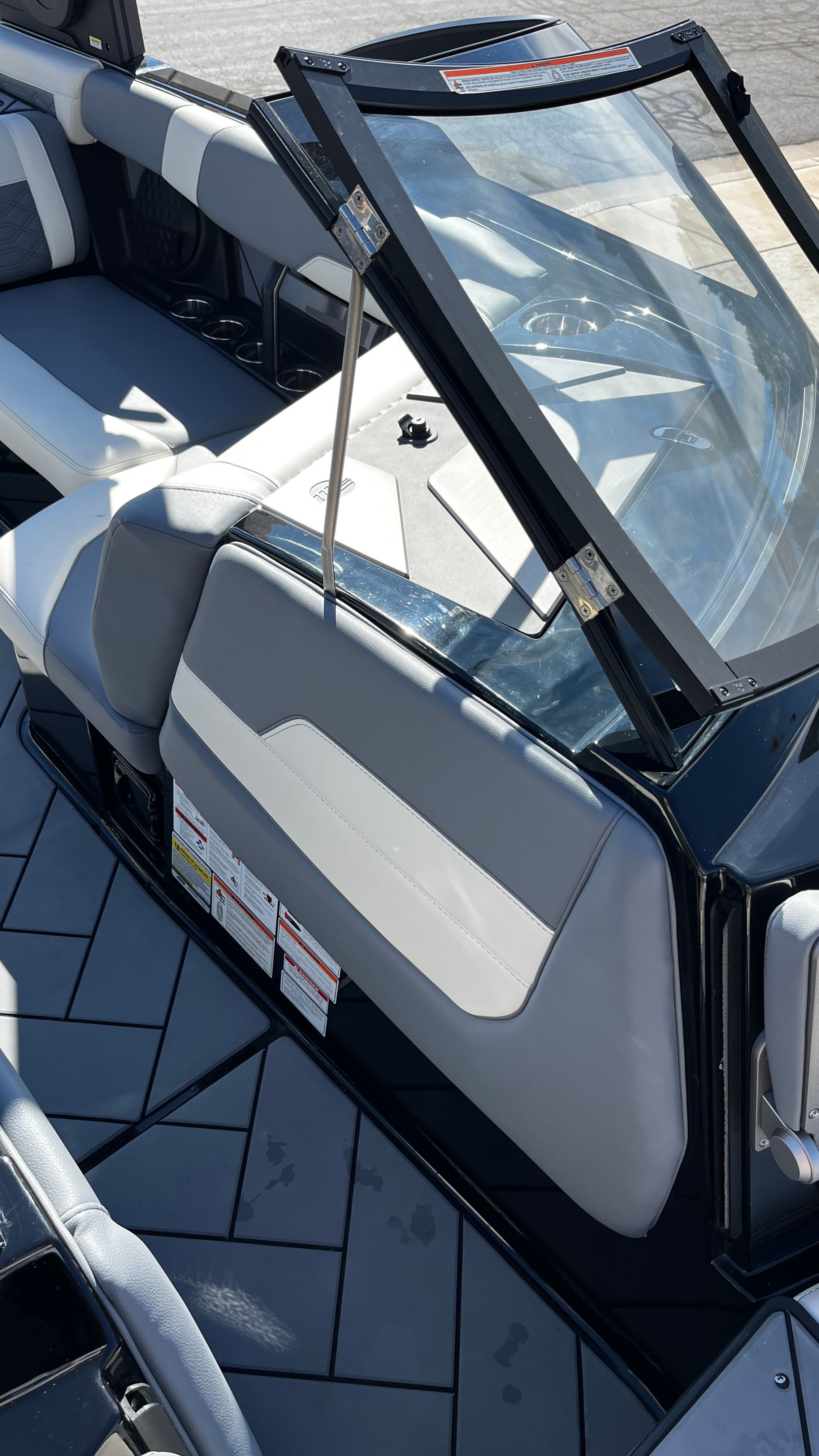 Interior view of a Malibu Wakesetter 26 LSV with gray upholstery and black frame.