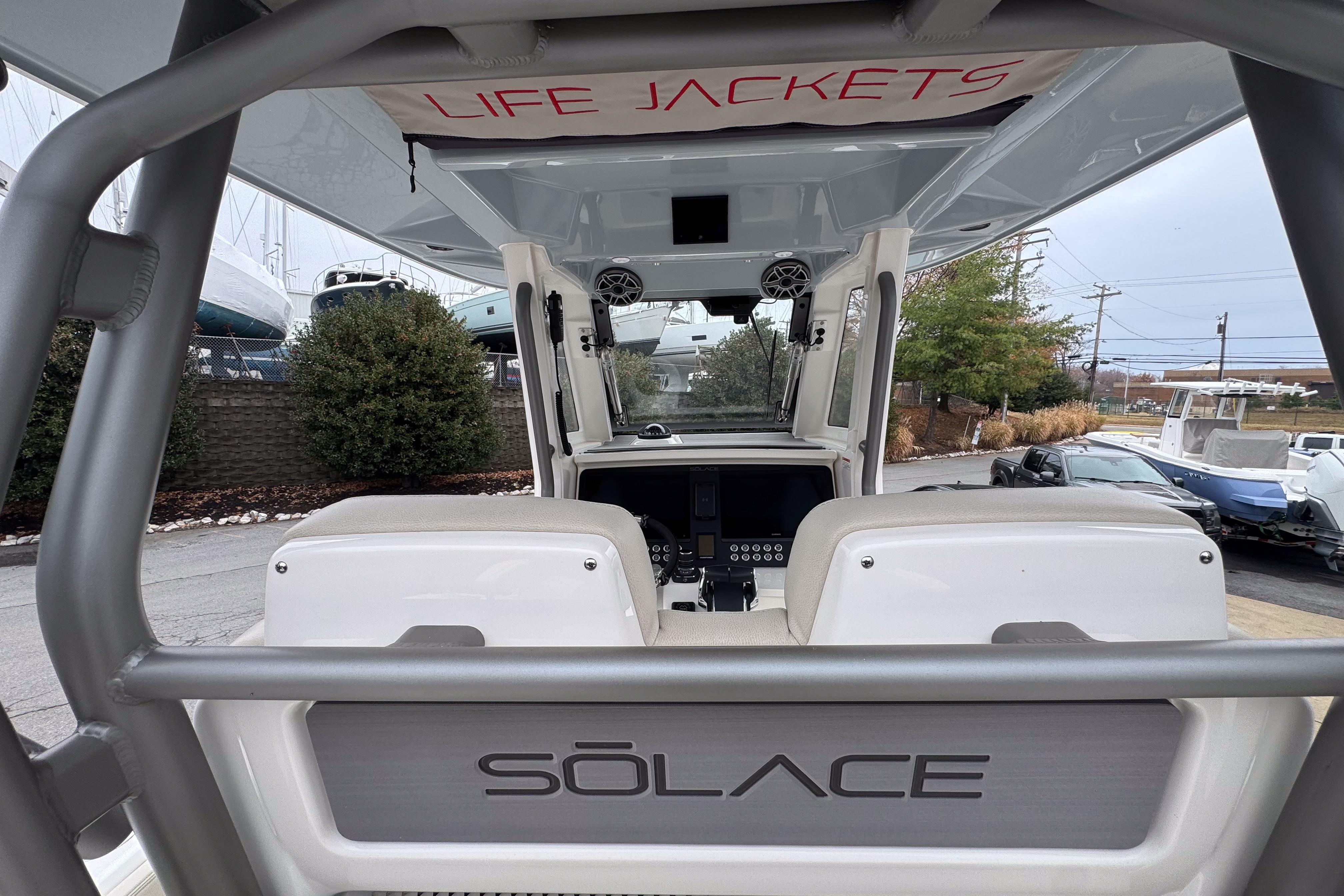 2025 Solace 30 HCS boat interior with life jackets storage and control panel.