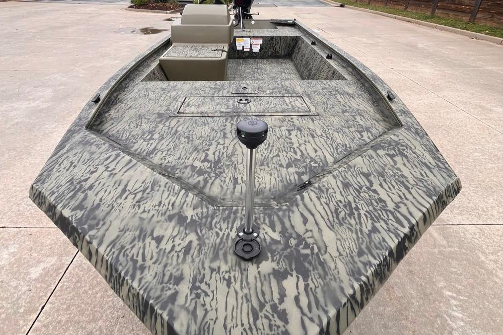 2026 Tracker Grizzly 1648 SC boat with camouflage pattern on concrete surface.