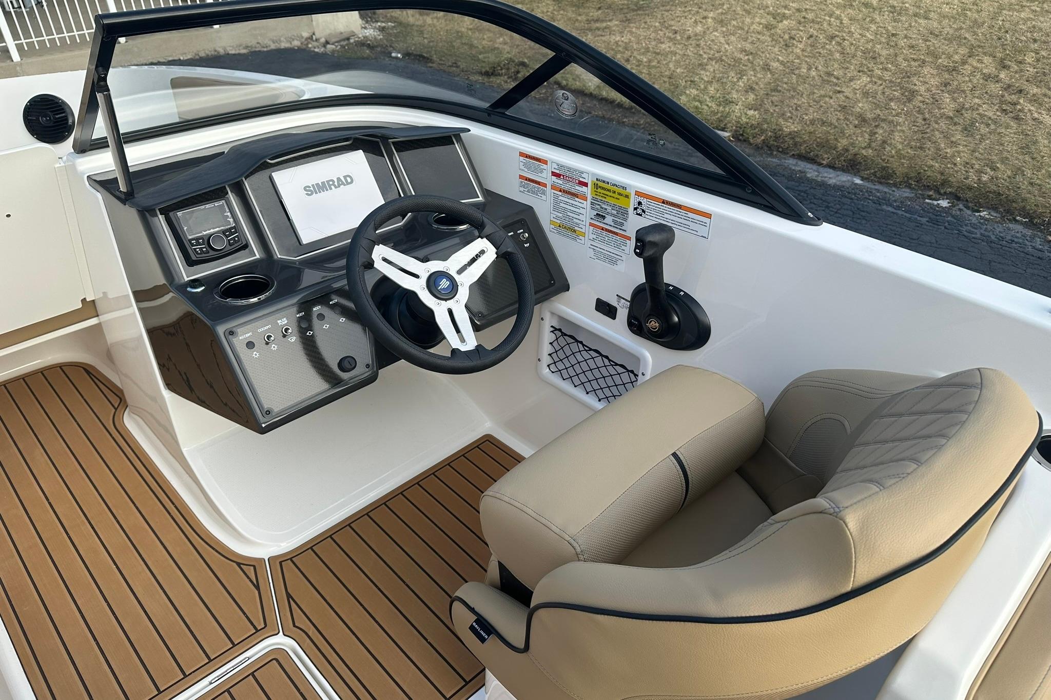 2026 Bayliner VR6 Bowrider OB cockpit with steering wheel and control panel.