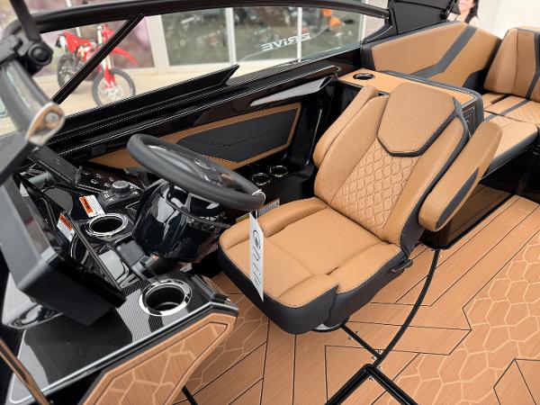2025 Yamaha Boats 255XD interior with tan seats and modern dashboard design.
