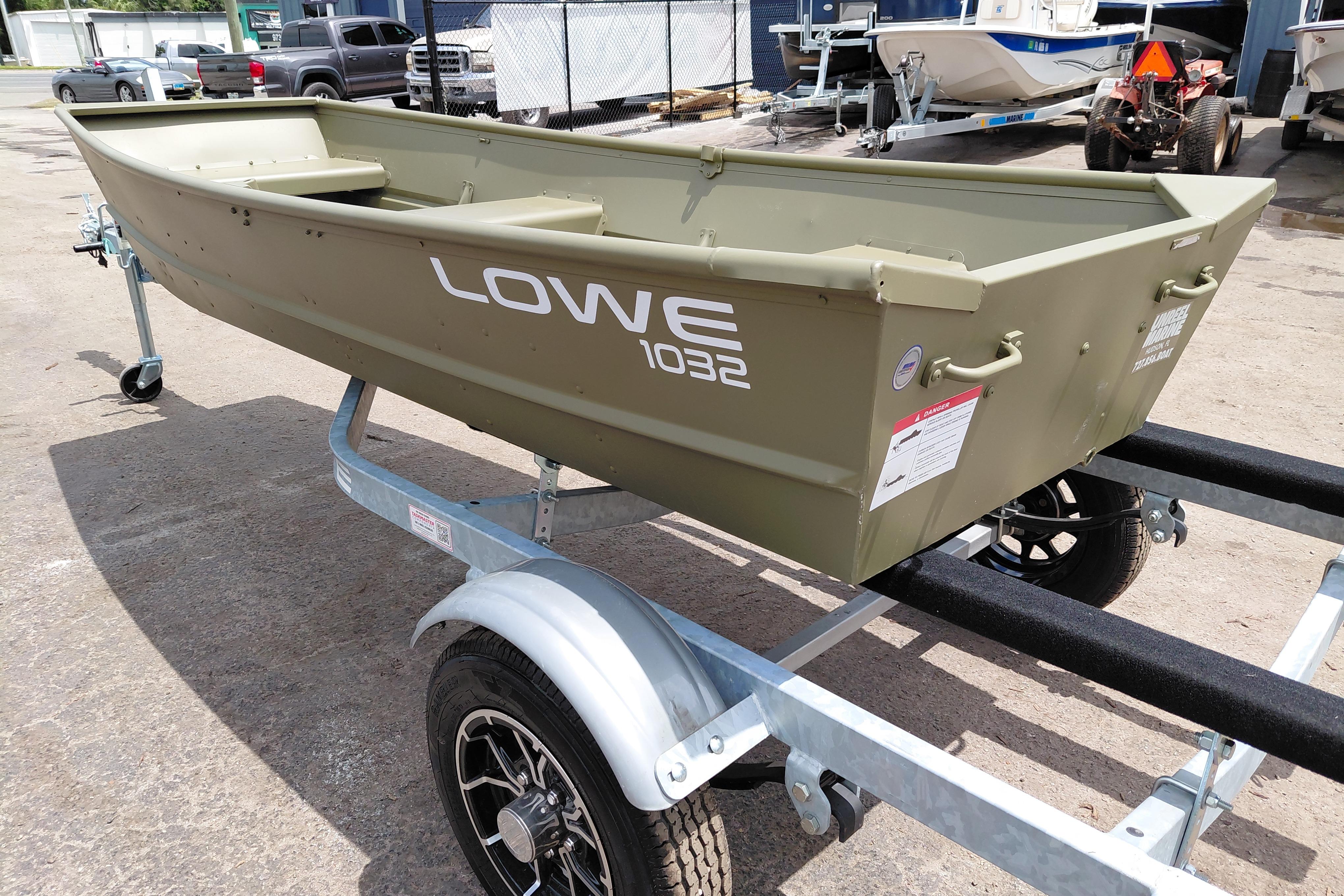 2026 Lowe L1032 Jon boat on trailer, parked outdoors.