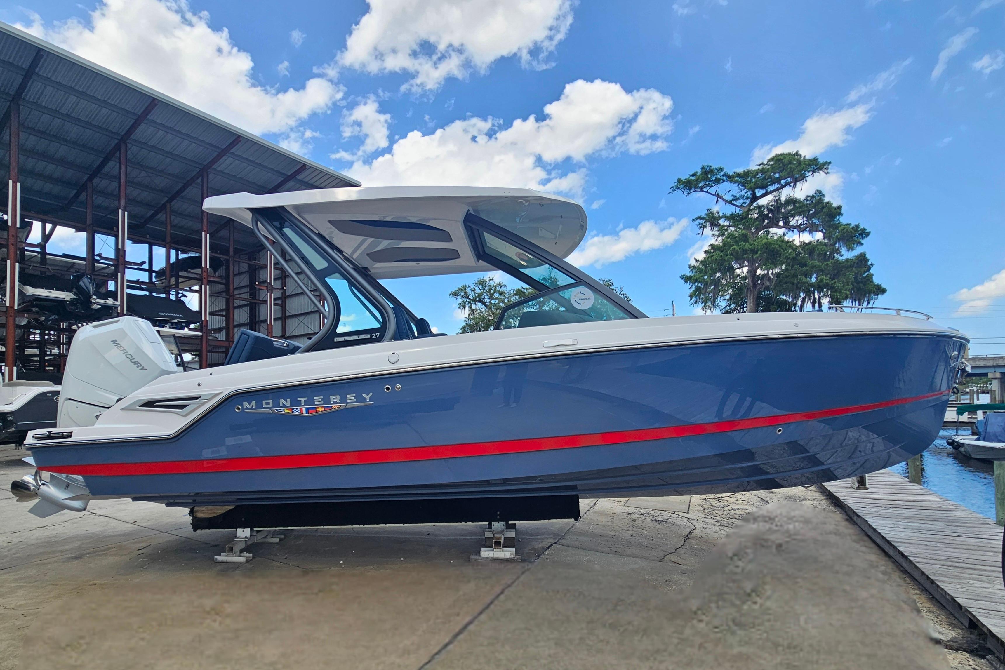 2026 Monterey Elite 27 OB boat docked under a clear blue sky.