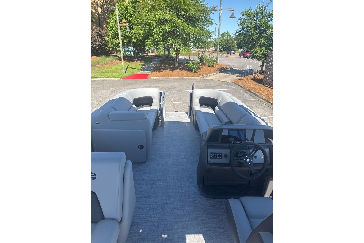 2026 Sun Tracker Party Barge 20 DLX interior with spacious seating and steering console.
