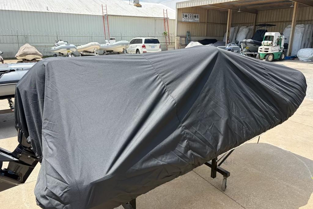 Covered 2026 Highfield Classic 360 boat in storage yard.