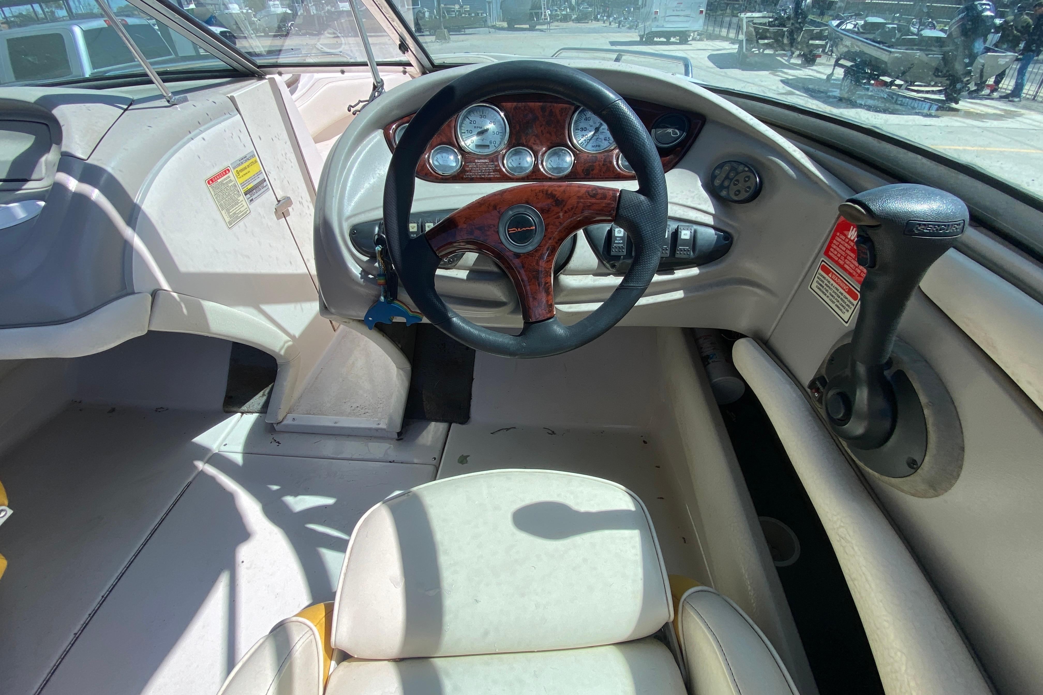 Interior view of 2003 Monterey 208SI Montura boat cockpit with steering wheel and controls.