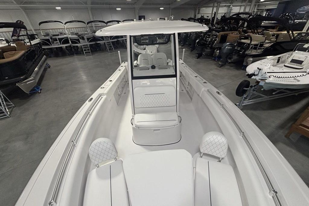 2026 Sportsman Open 252 Center Console boat in showroom, featuring sleek design and spacious seating.