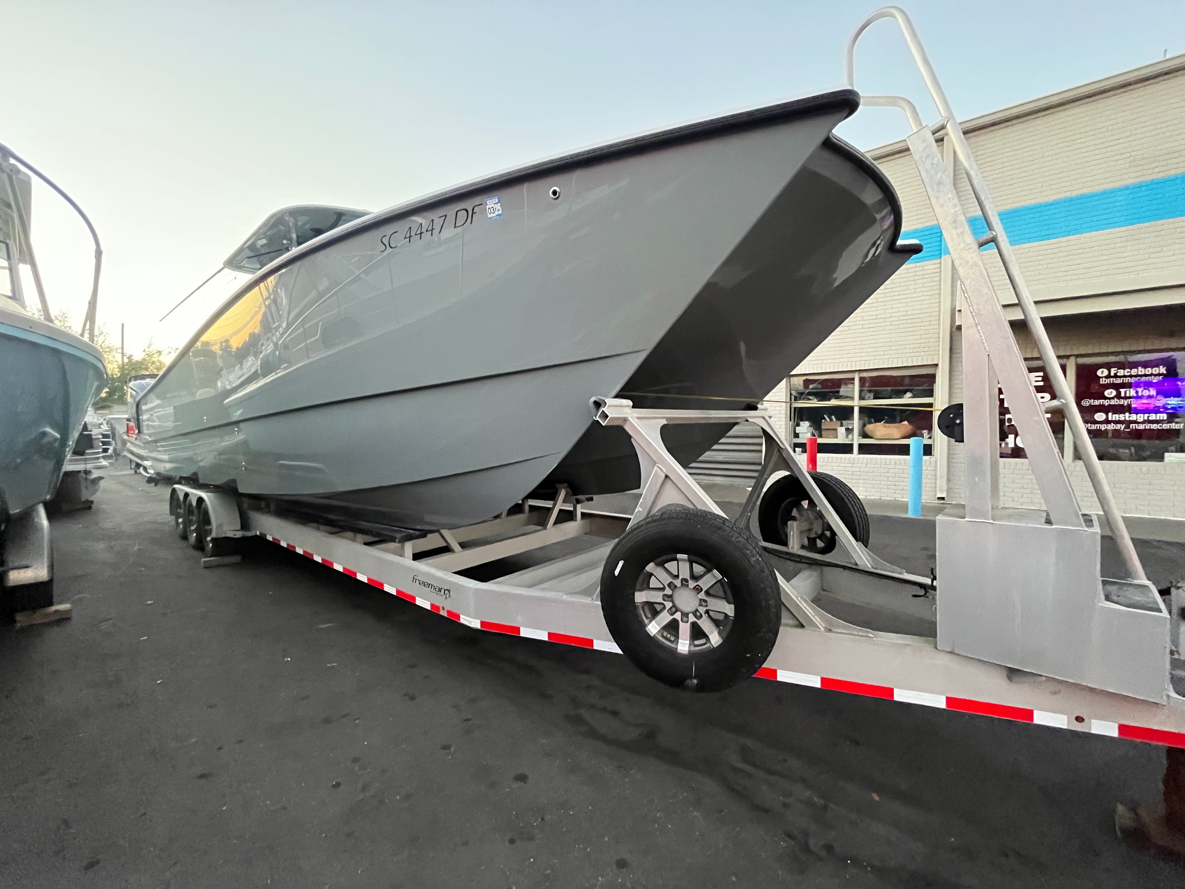 2017 Freeman 37VH boat on trailer in front of building.