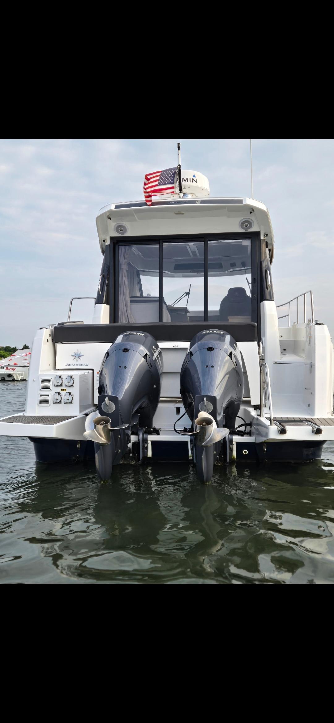 2021 Jeanneau NC895 boat with dual outboard motors on water.