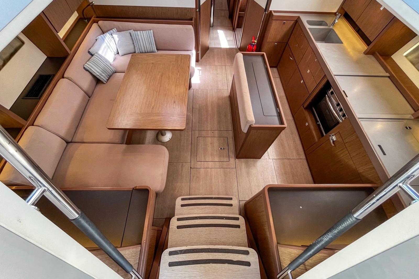 Interior of 2018 Beneteau Sense 51 yacht, featuring a spacious dining and kitchen area.