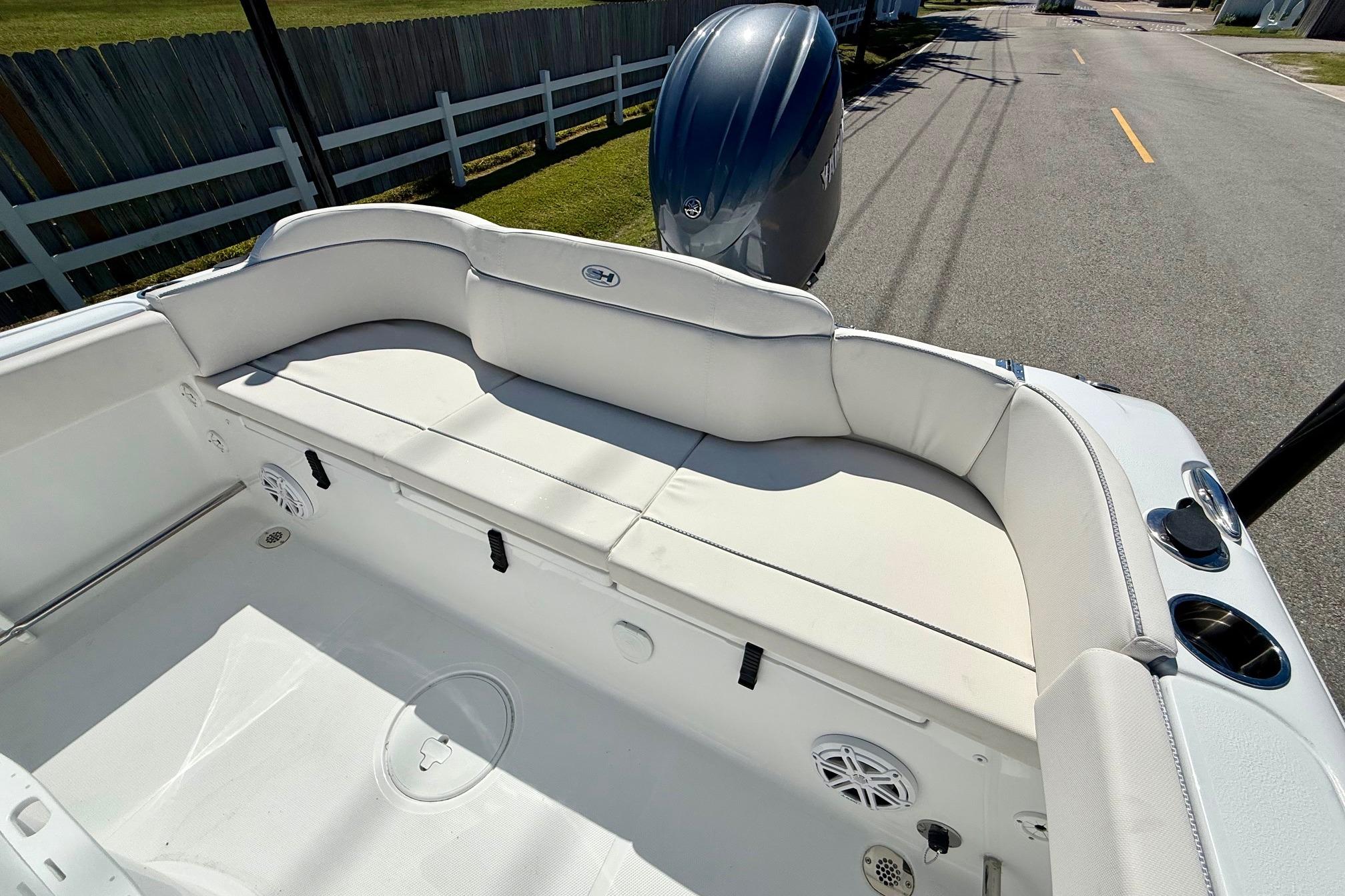 2026 Sea Hunt Ultra 229 boat interior with white seating and Yamaha outboard motor.