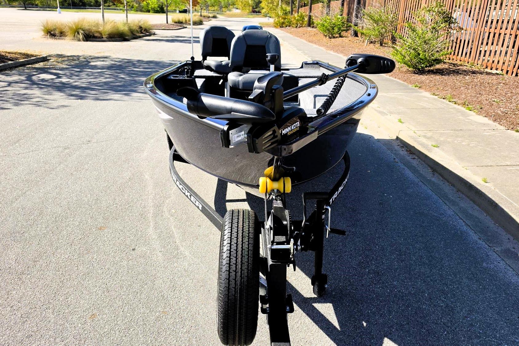 2026 Tracker Super Guide V-16 T boat on trailer, parked on a sunny street.