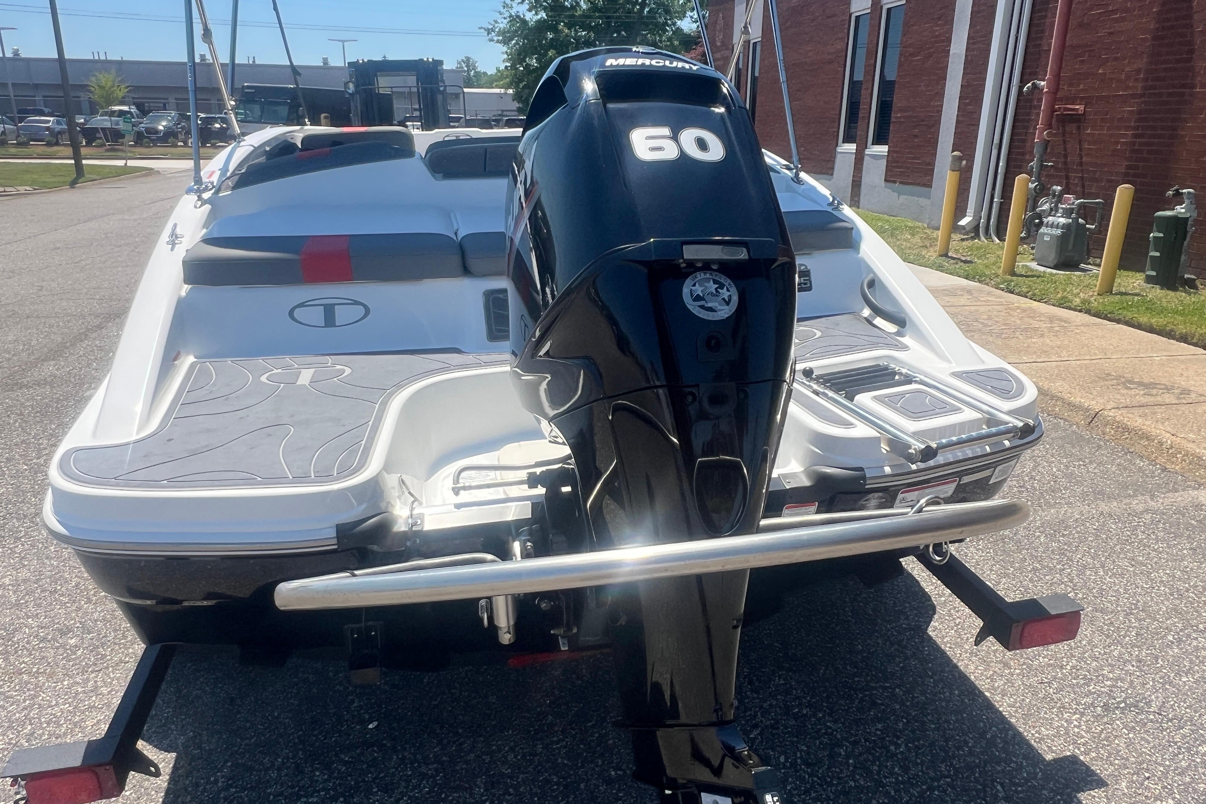 2023 Tahoe T16 boat with Mercury 60 outboard motor, parked on a sunny street.