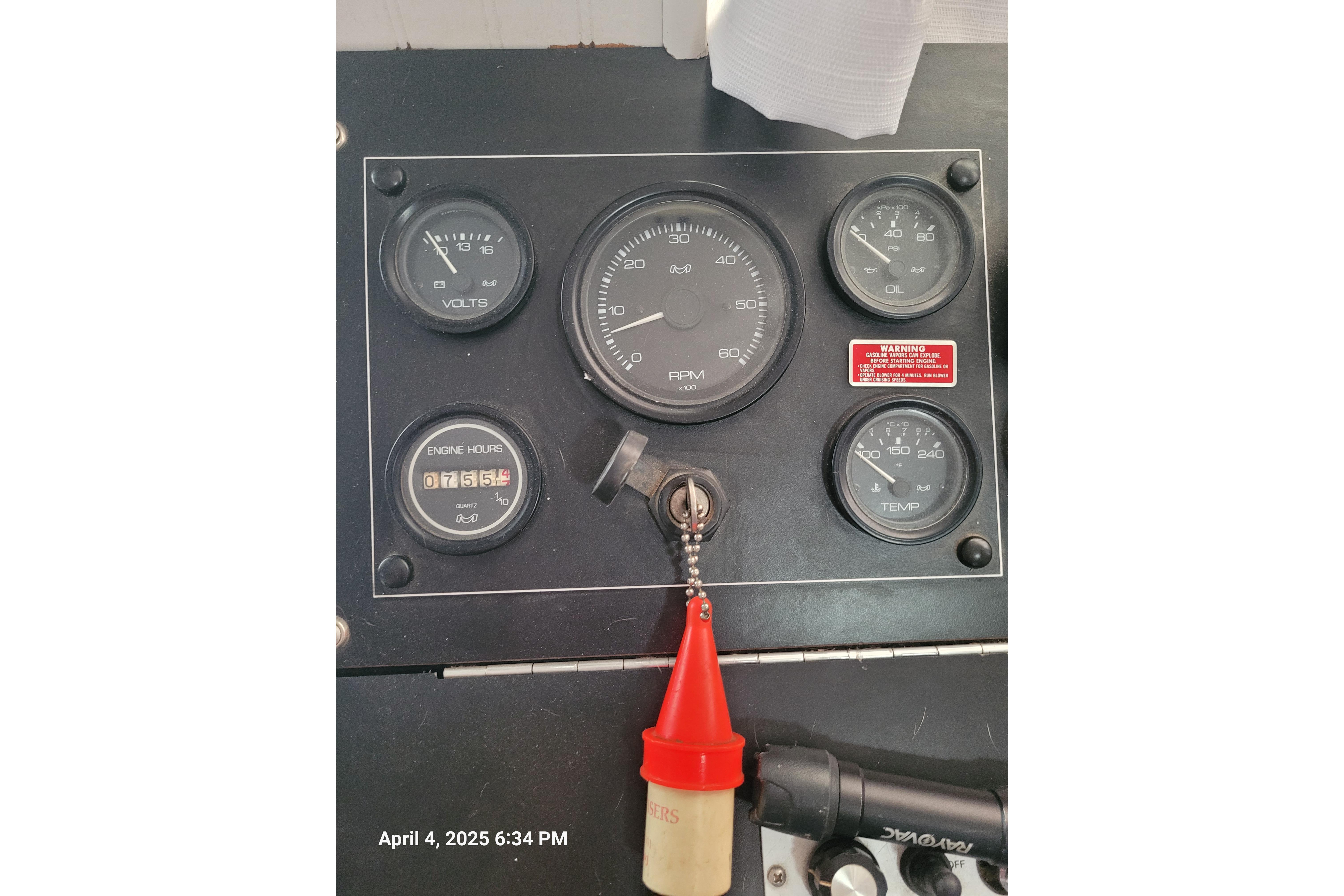 Control panel of a 1990 Sumerset 16 x 70 houseboat with gauges and key.